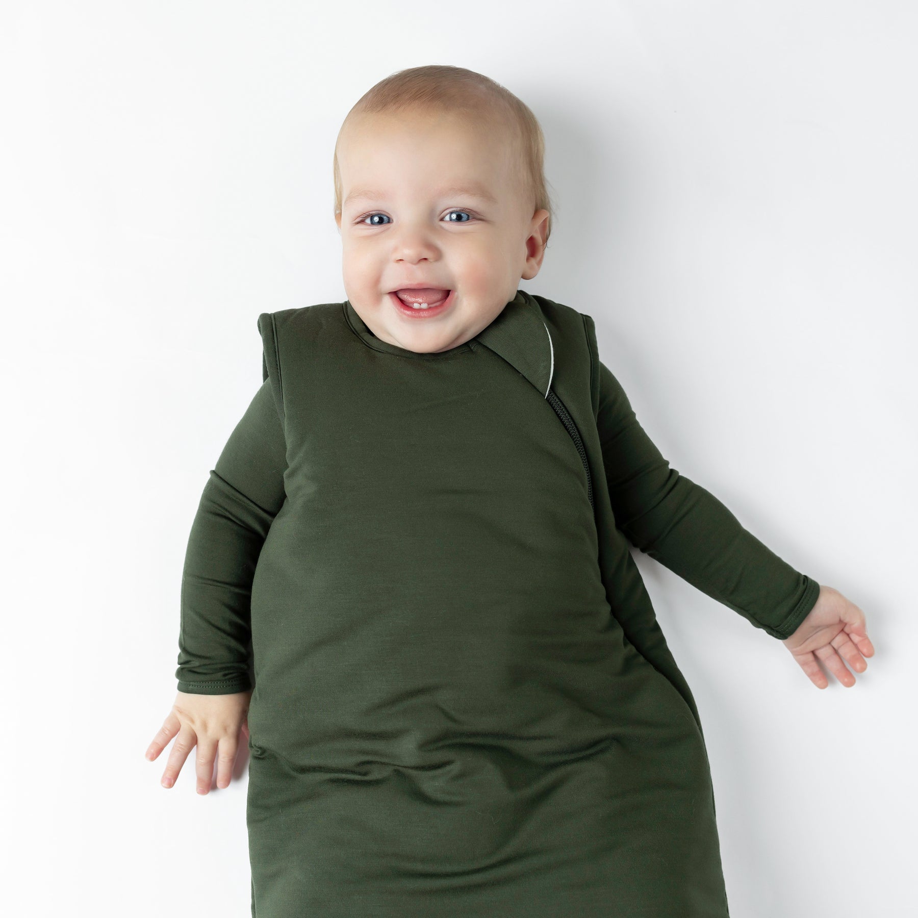 Close up of Baby wearing Sleep Bag in Fir 2.5 on a white background