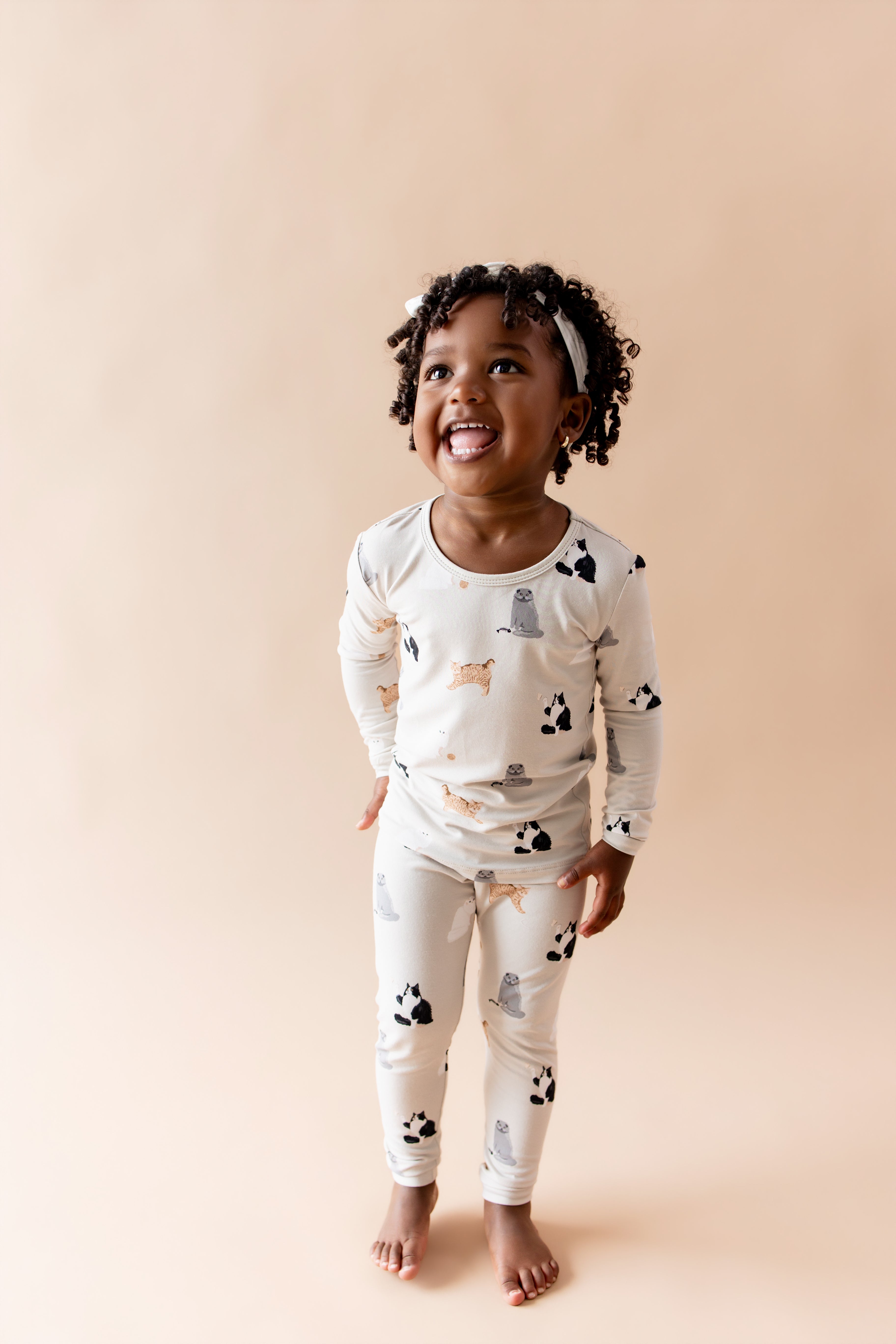 Smiling girl wearing the Long Sleeve Pajamas in Fluffy Cat