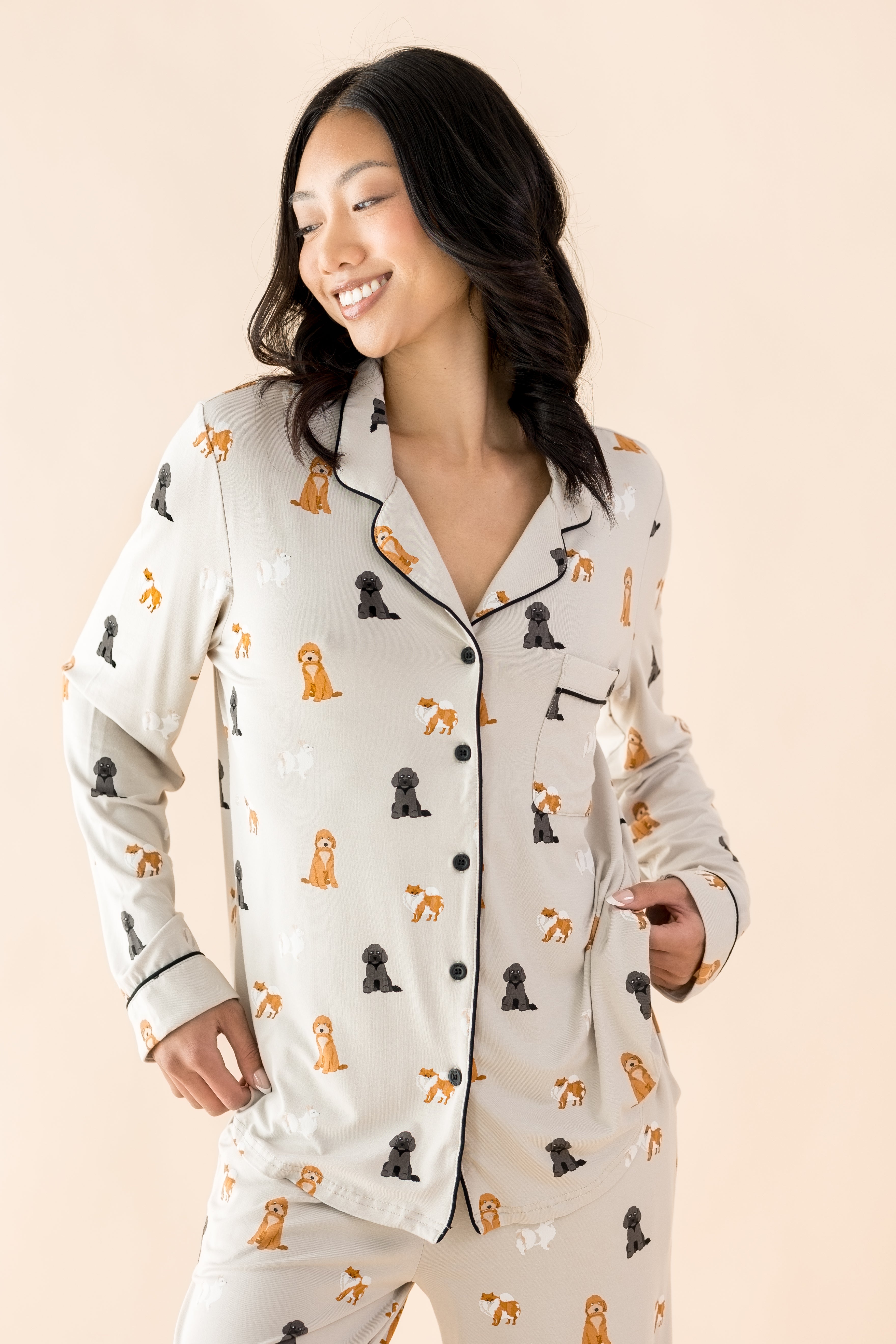 The shirt of the Long-Sleeved Women's Pajama Set in Fluffy Dog shown on a smiling female model