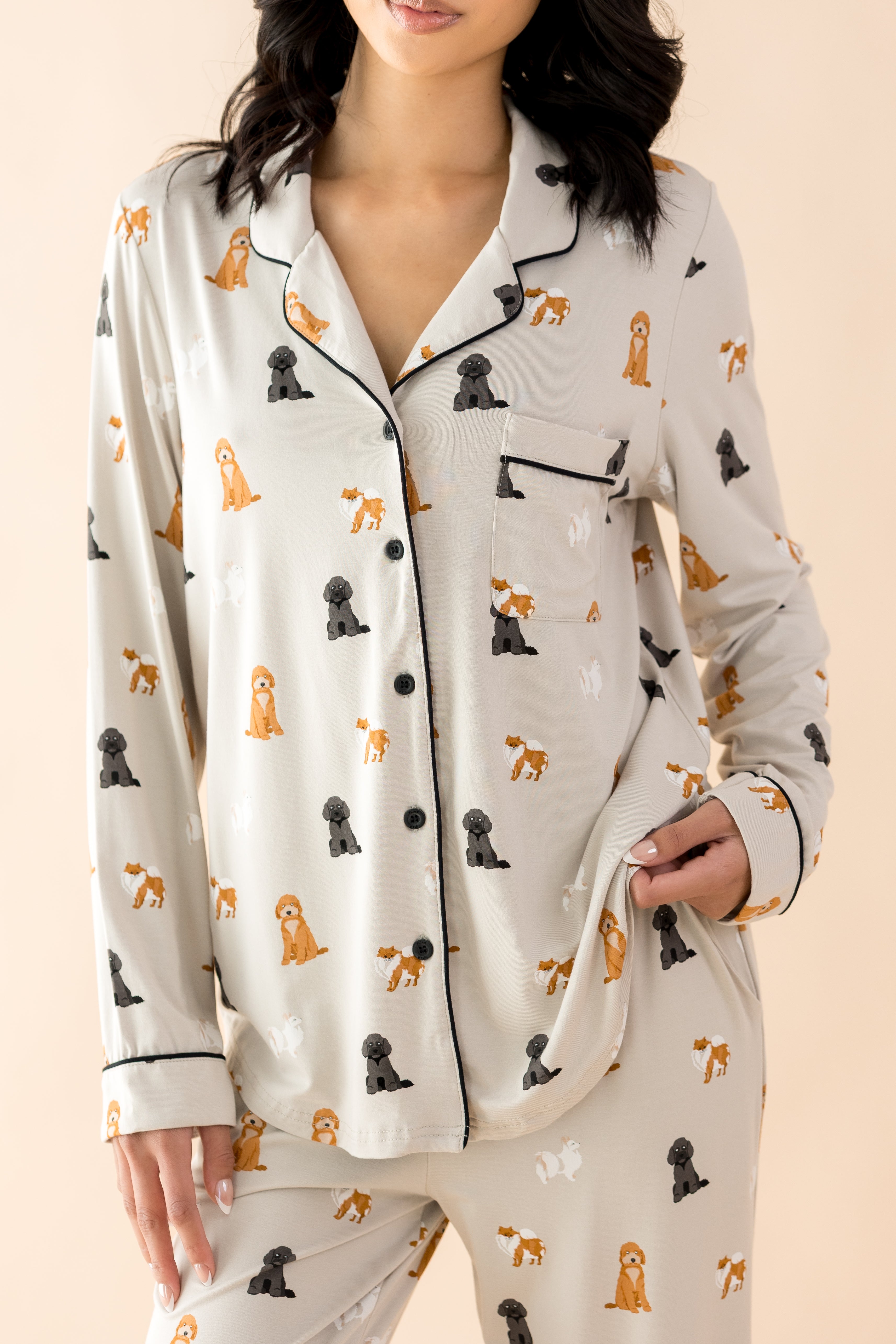 Close up of the button closure, trim and chest pocket on the shirt shown on the Long-Sleeved Women's Pajama Set in Fluffy Dog