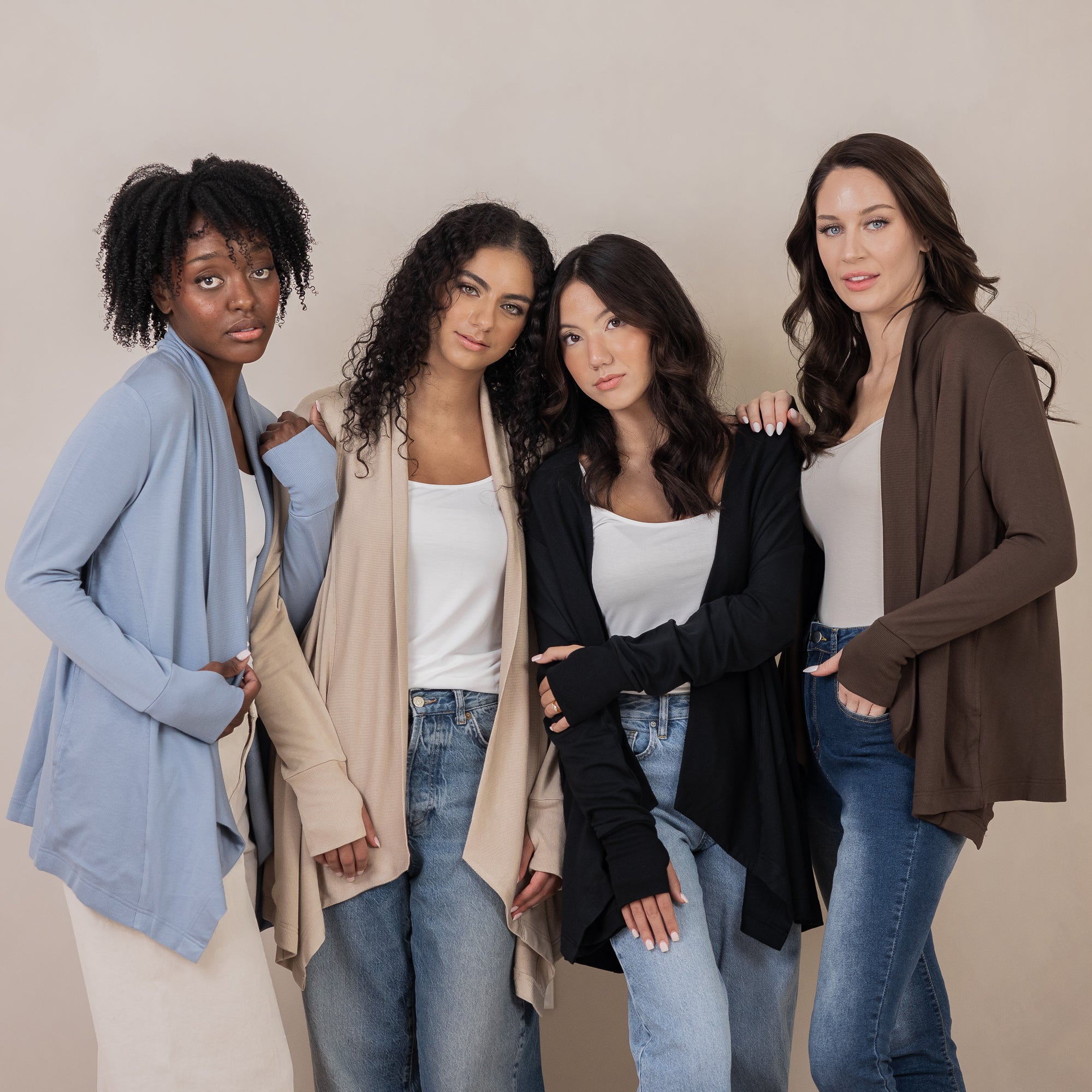 Four models standing side by side wearing the Women's French Terry Wrap Top in Almond, Slate, Midnight and Espresso