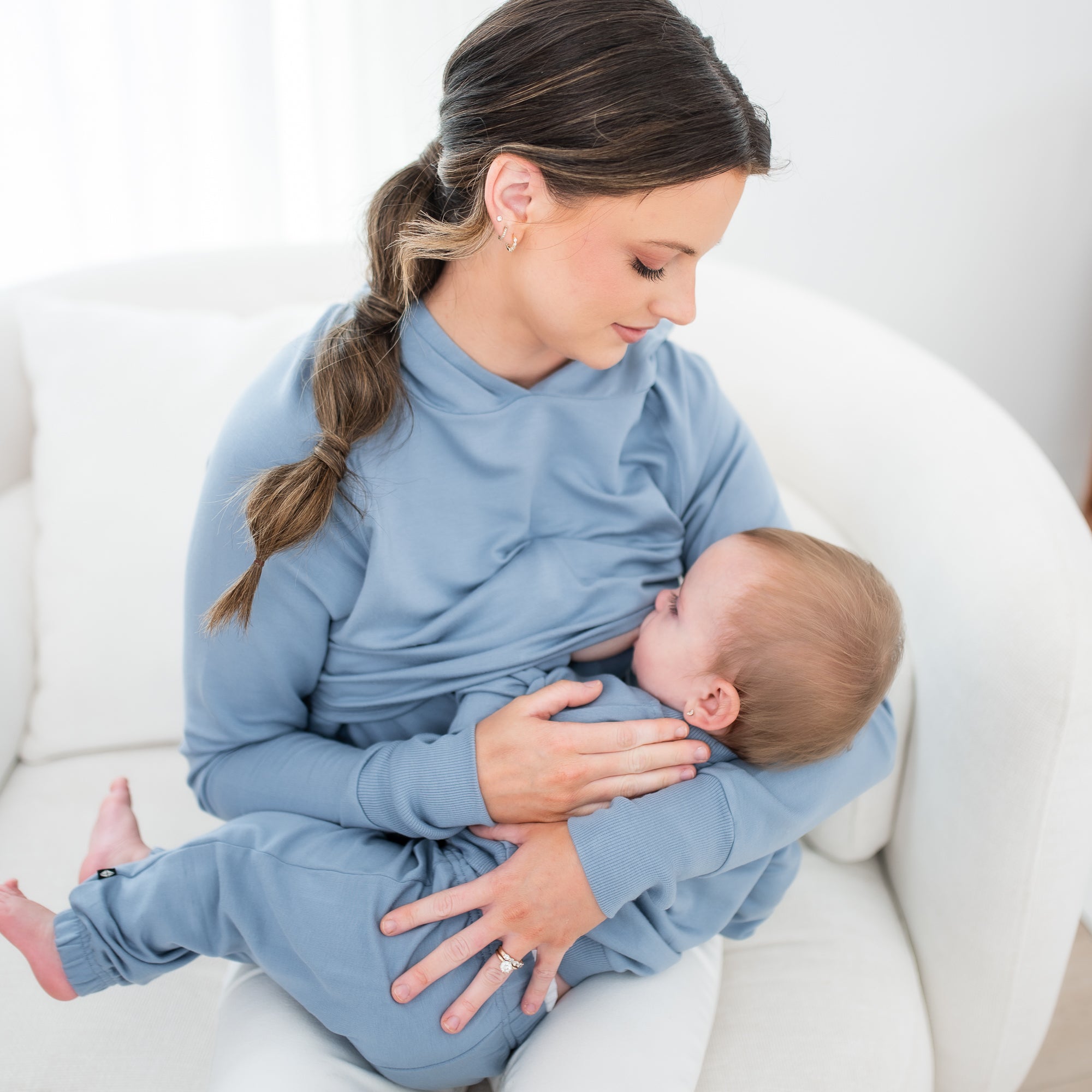 Mother wearing the Women's French Terry Nursing Hoodie in Slate nursing her infant who is matching in a french terry jogger set