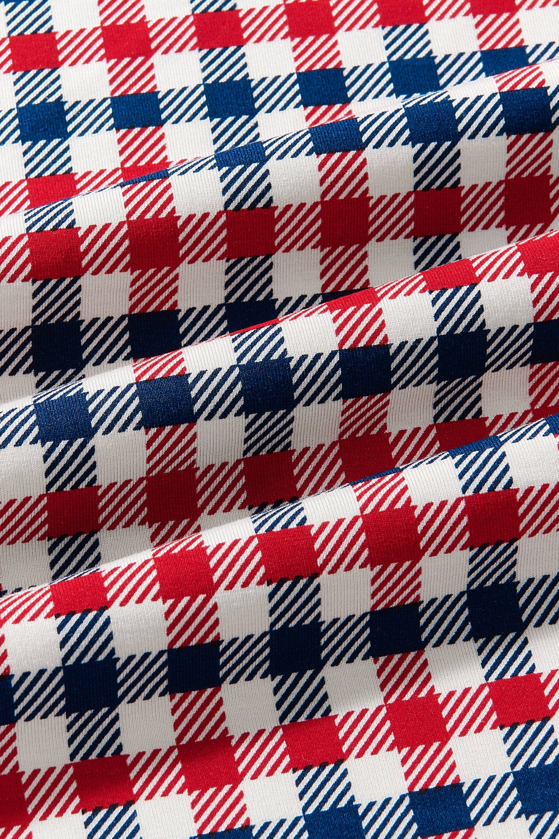 Close up of fabric with blue red and white Patriotic Gingham check print