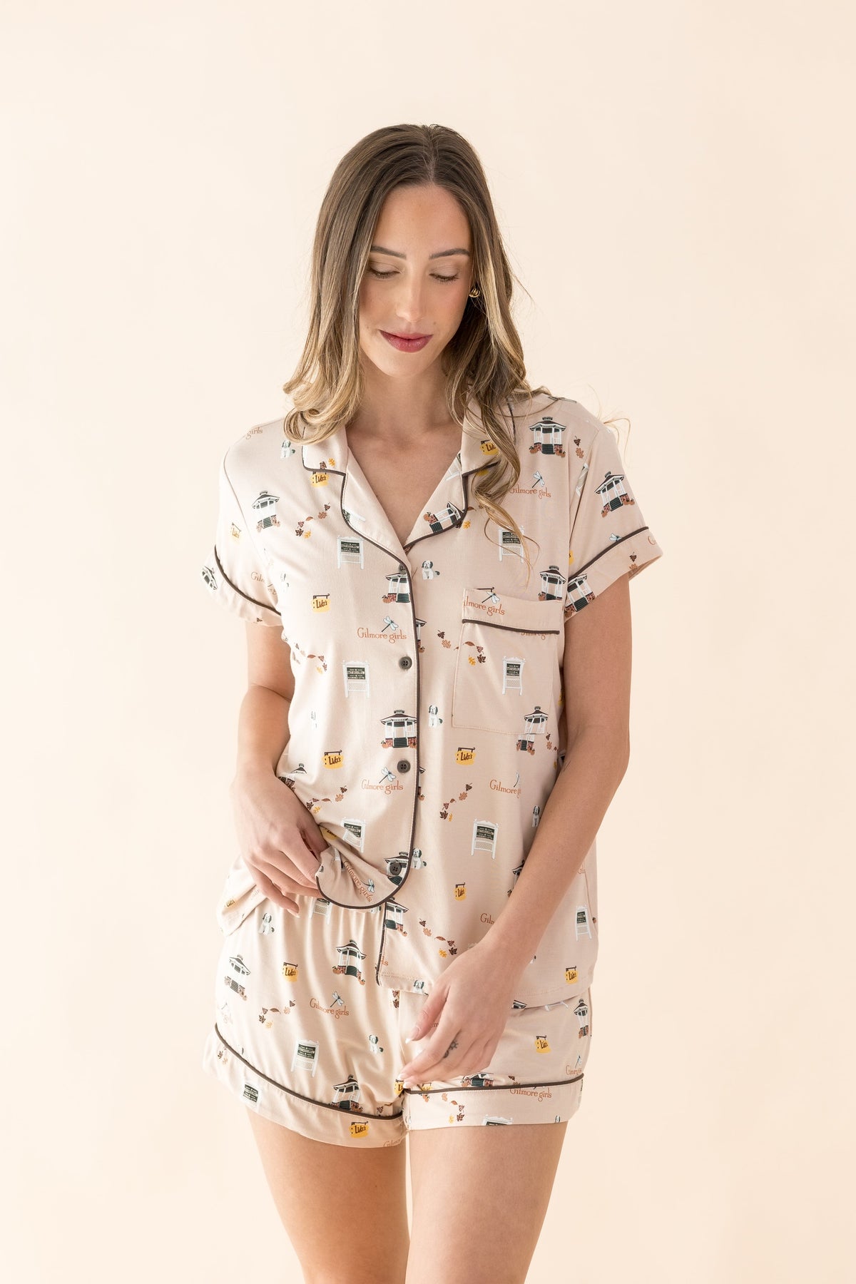 Female modeling the Women's Short Sleeve Pajama Set in Gilmore Girls standing in front of a light neutral background