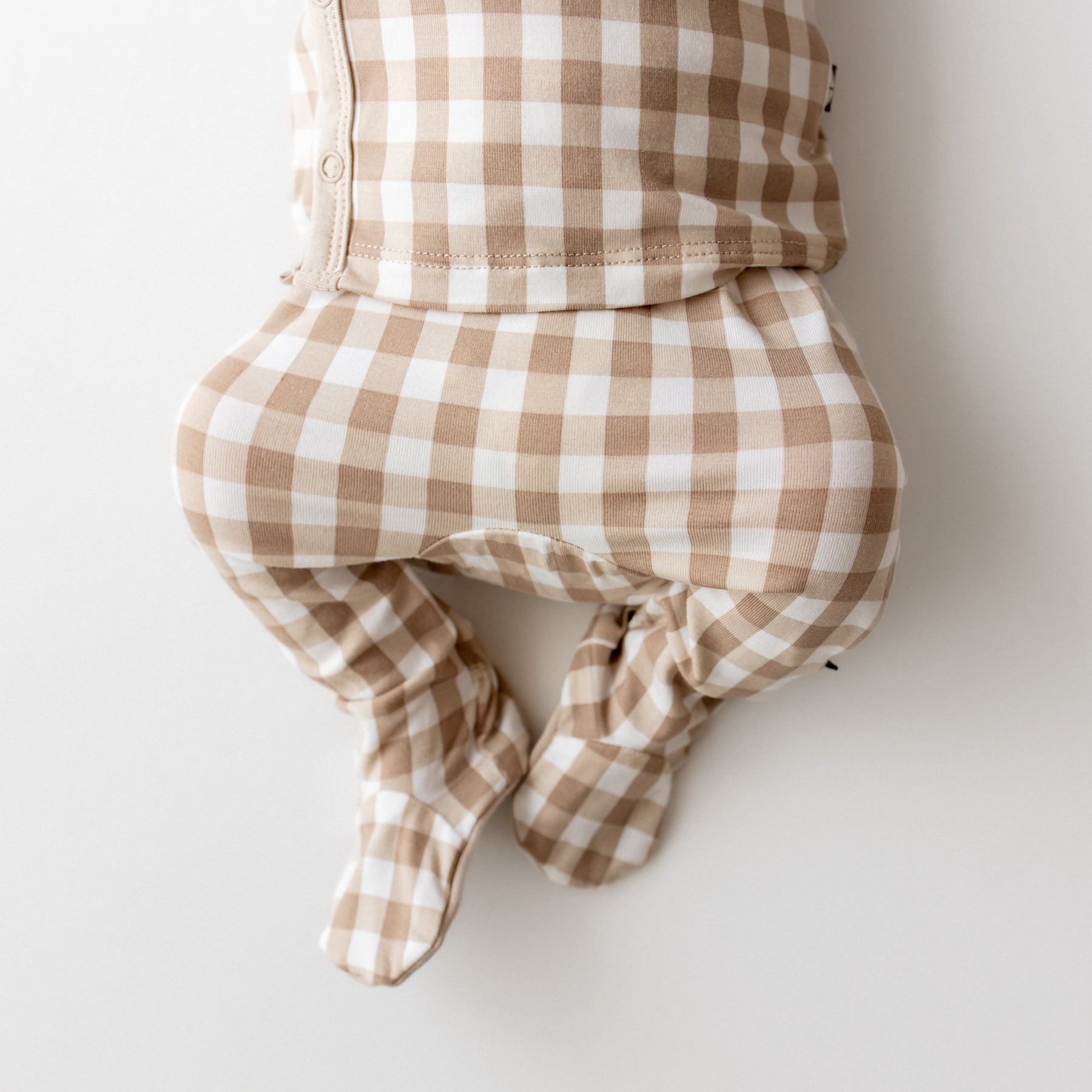 Close up of the pants of the Take Me Home Set with Cap in Gingham Bisque shown on a newborn