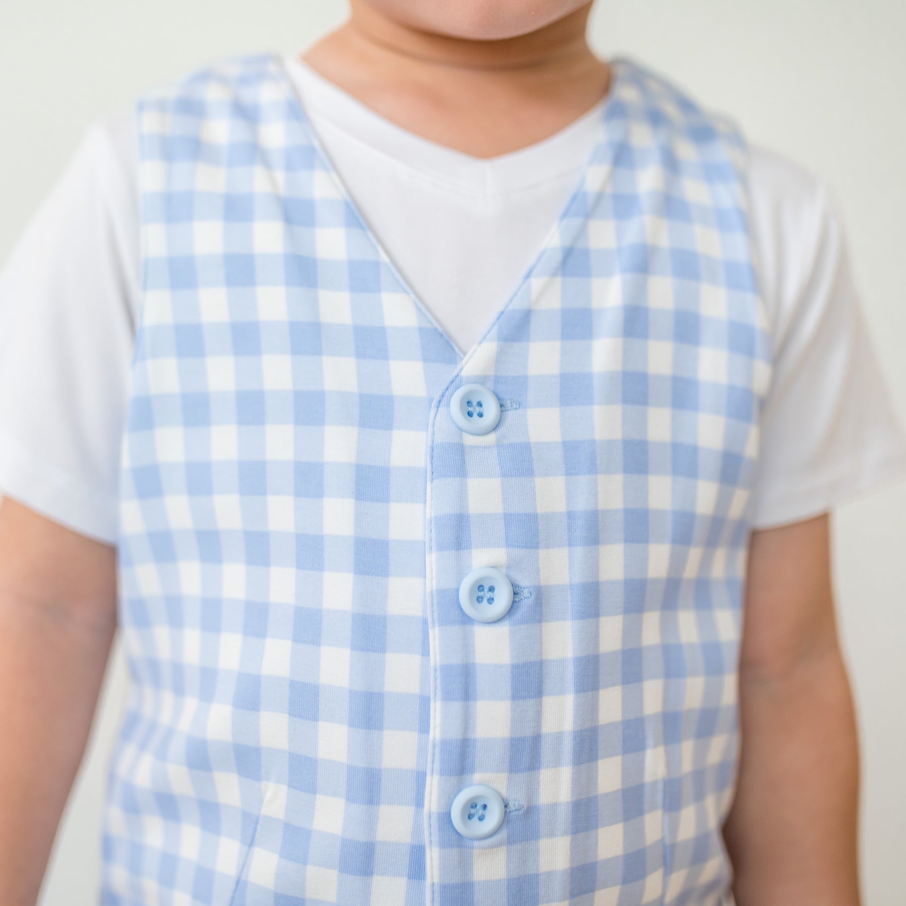 Close up of the button closures shown on the Tuxedo Vest in Gingham Breeze