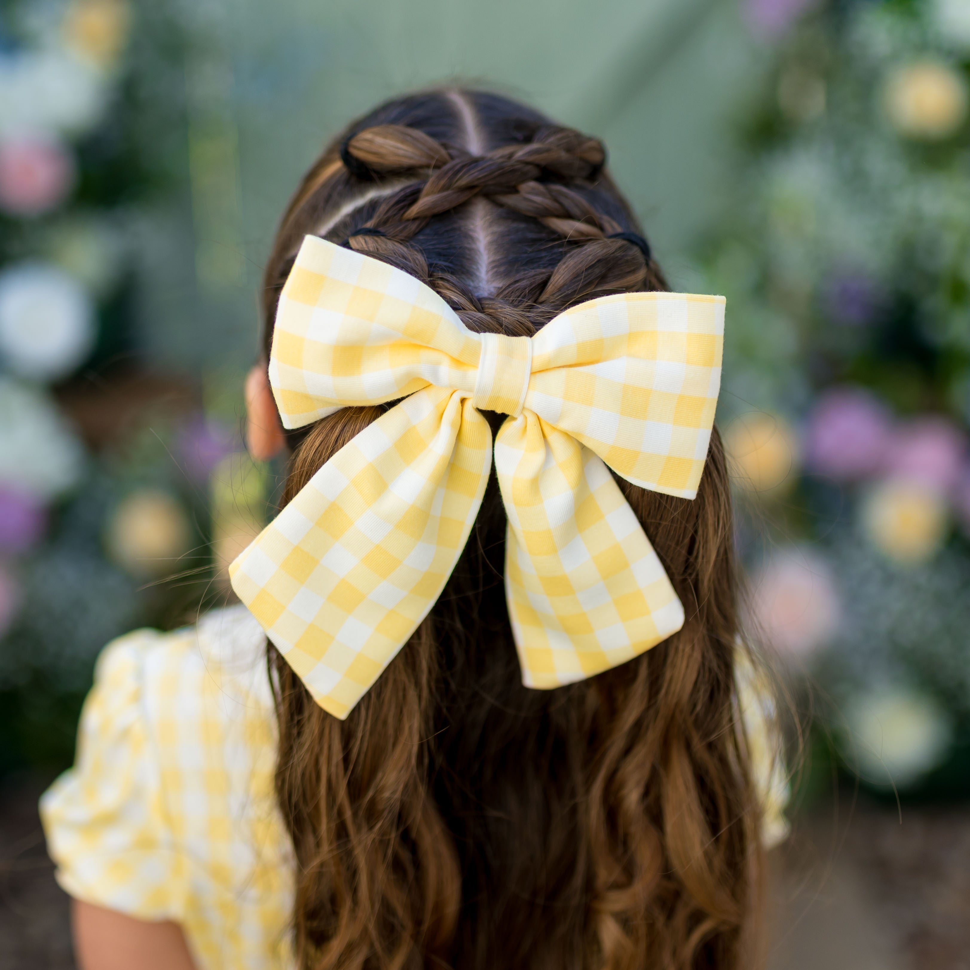 Large Alligator Clip Bow in Gingham Chamomile shown in the hair of a young girl model