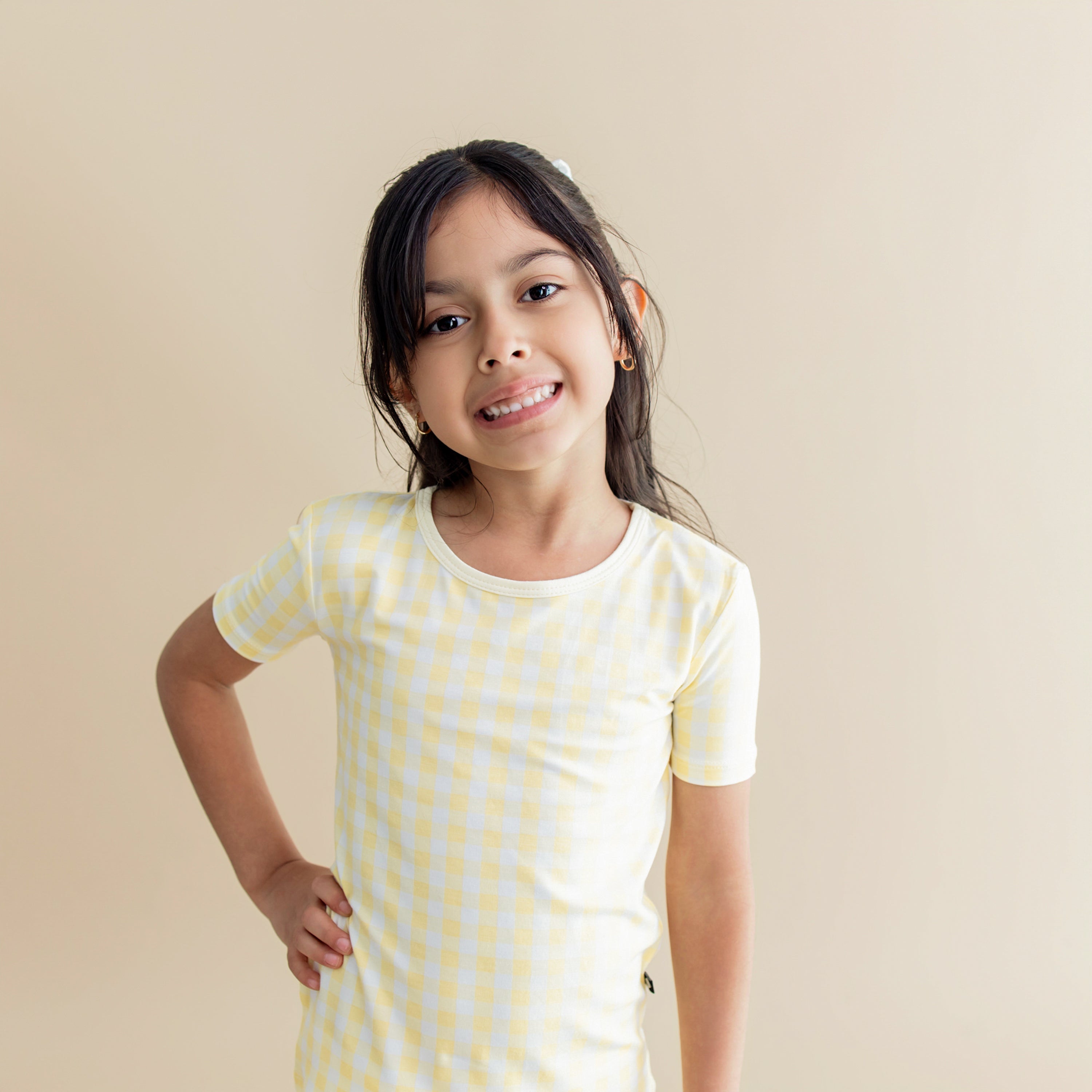 Close up of the shirt on a young girl from the Short Sleeve Pajamas in Gingham Chamomile