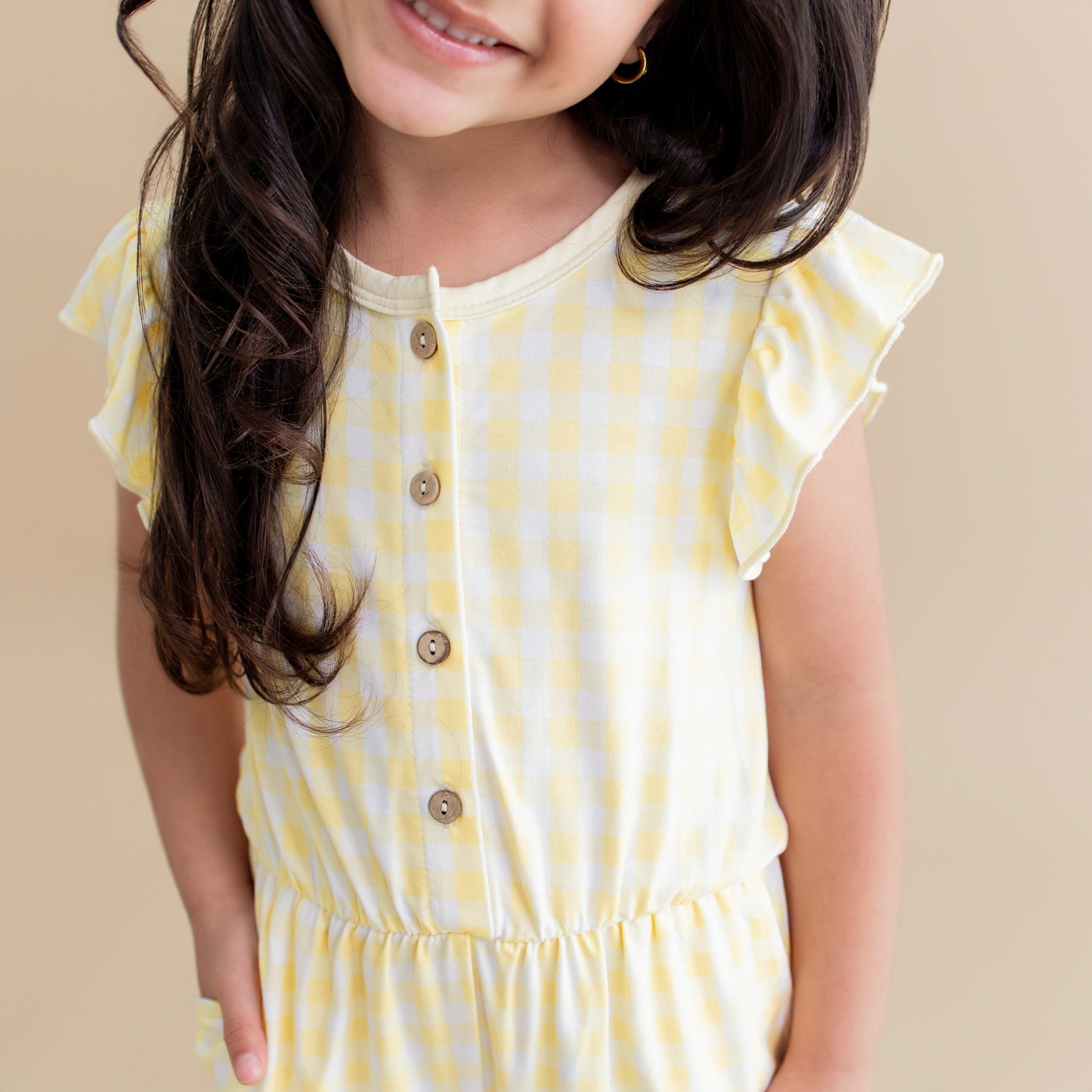 Close up of the flutter sleeve and button closure on the Flutter Sleeve Romper in Gingham Chamomile