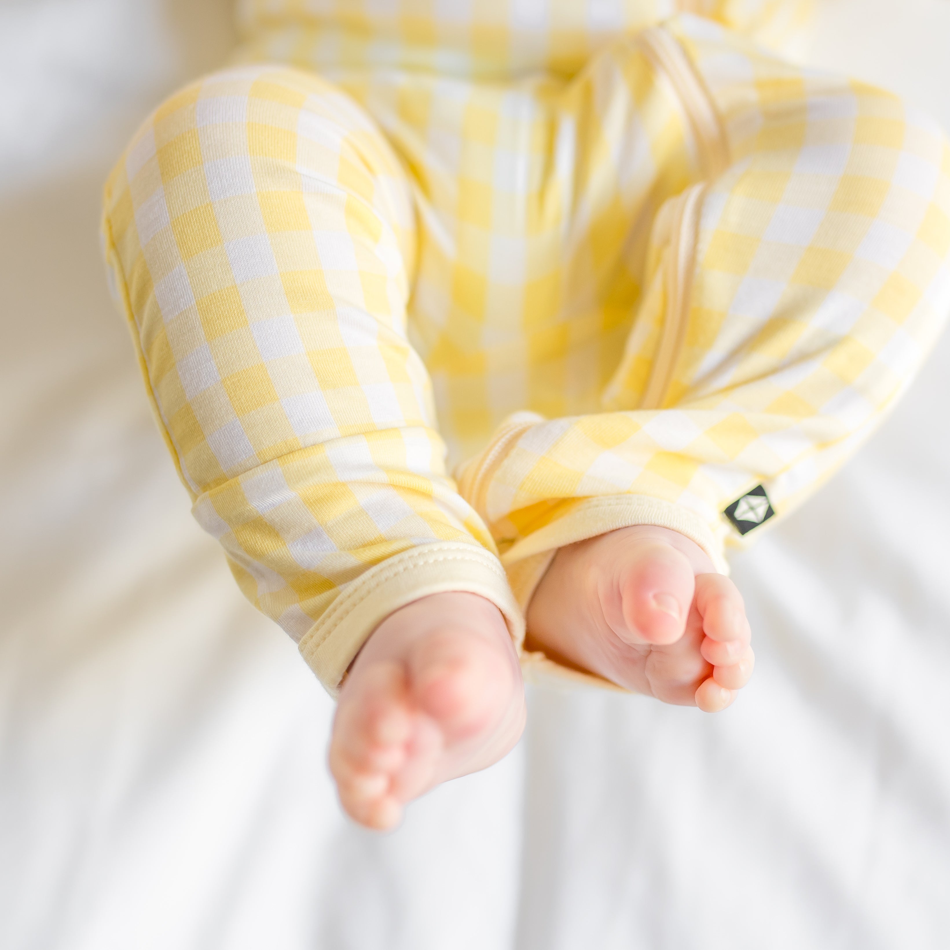 Close up of the ankle seams and zipper on the leg of the Zippered Romper in Gingham Chamomile