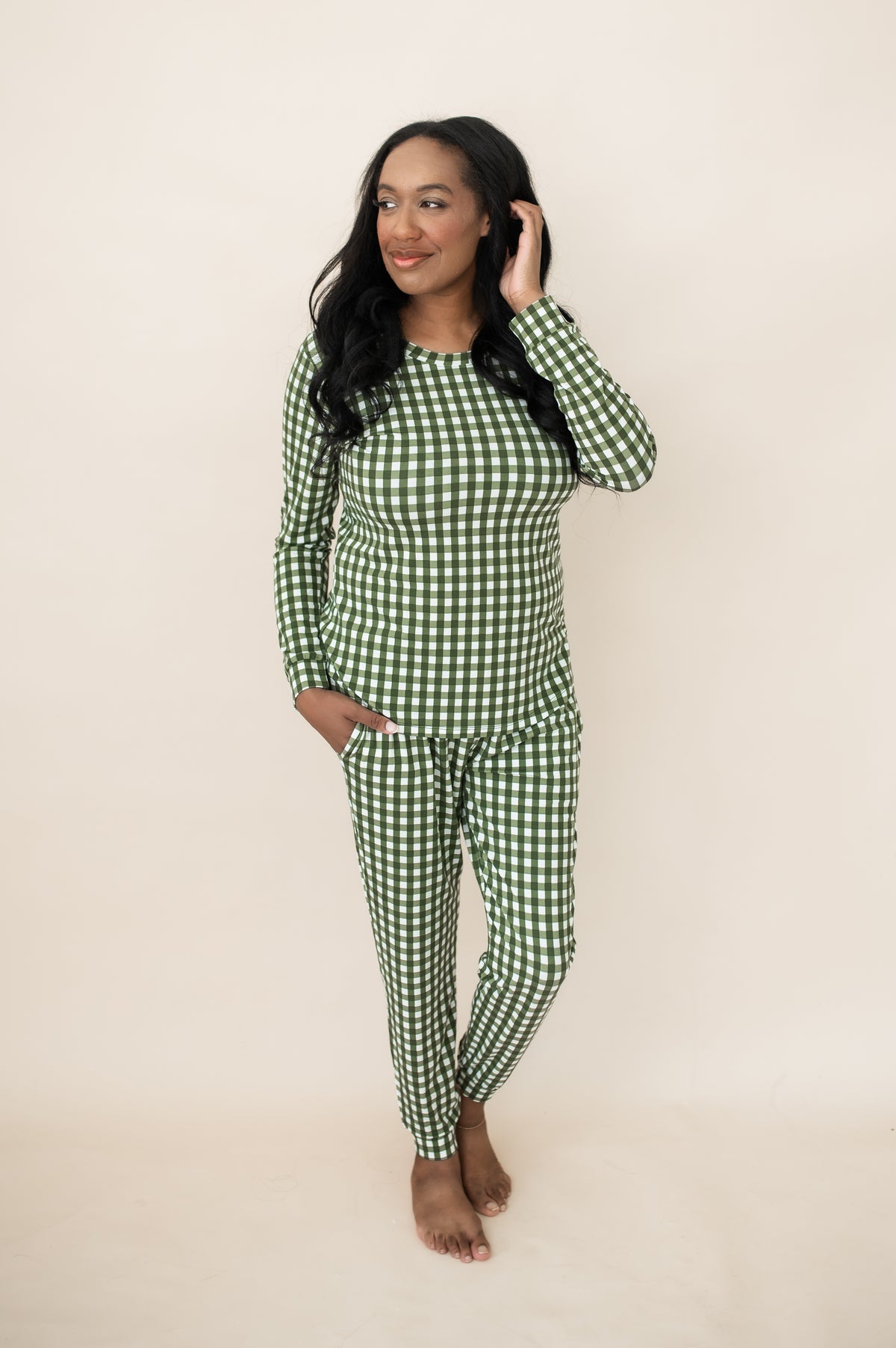 Female posing wearing the Women's Jogger Pajama Set in Gingham Fir in front of a light neutral background