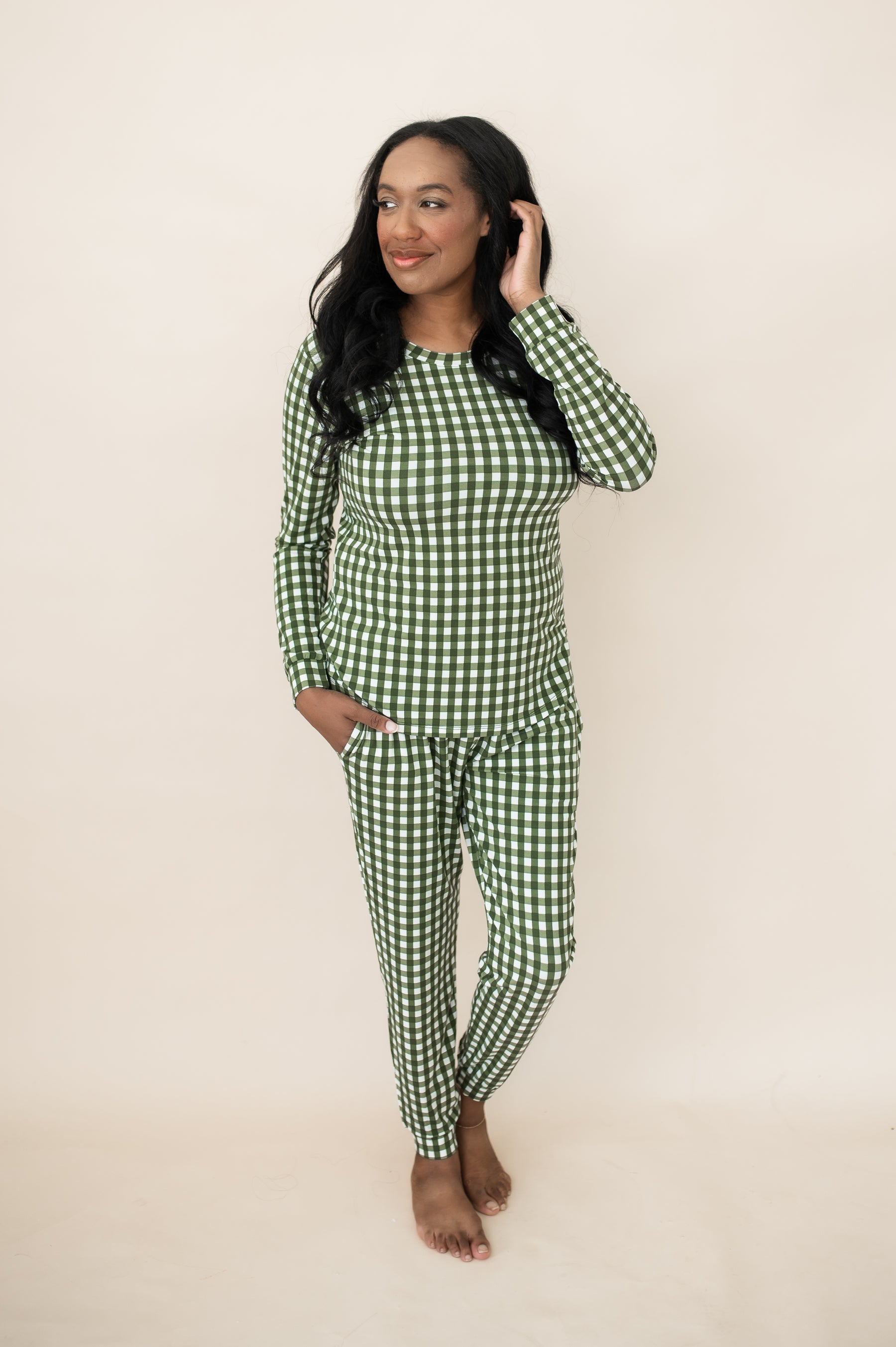 Female posing wearing the Women's Jogger Pajama Set in Gingham Fir in front of a light neutral background