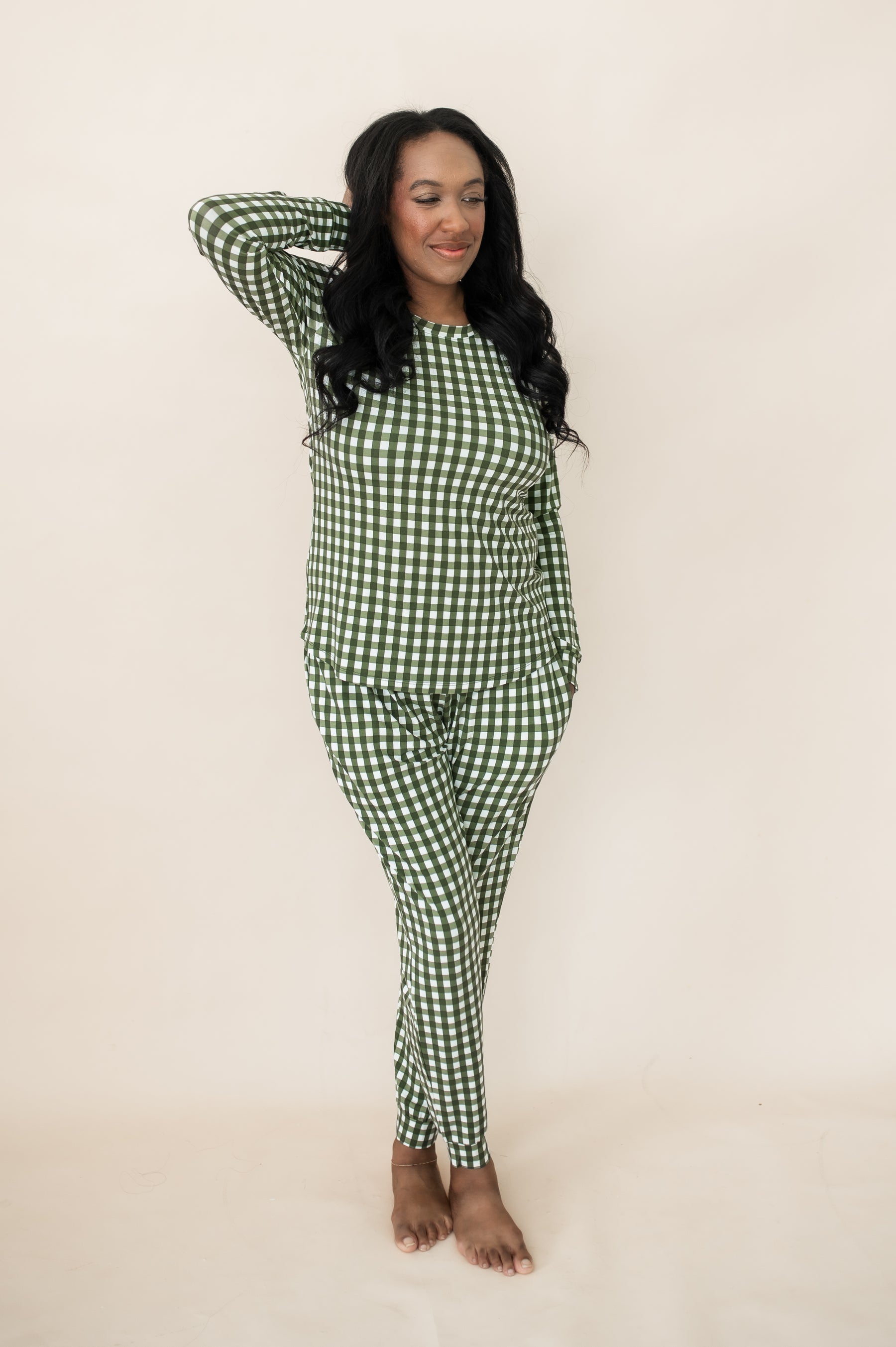 Female model wearing the Women's Jogger Pajama Set in Gingham Fir with one hand behind her head