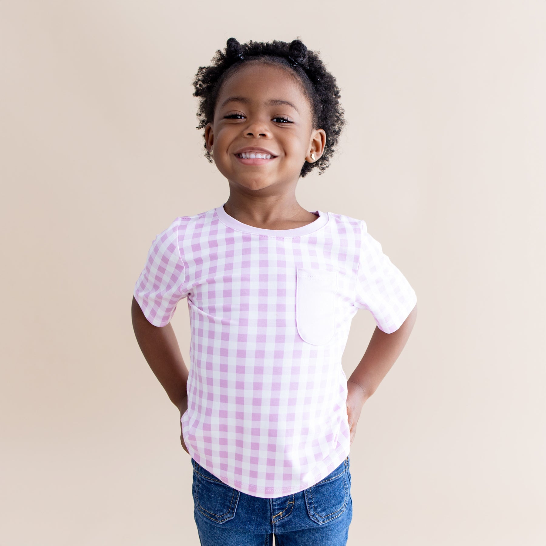 Smiling girl wearing the Toddler Crew Neck Tee in Gingham Thistle