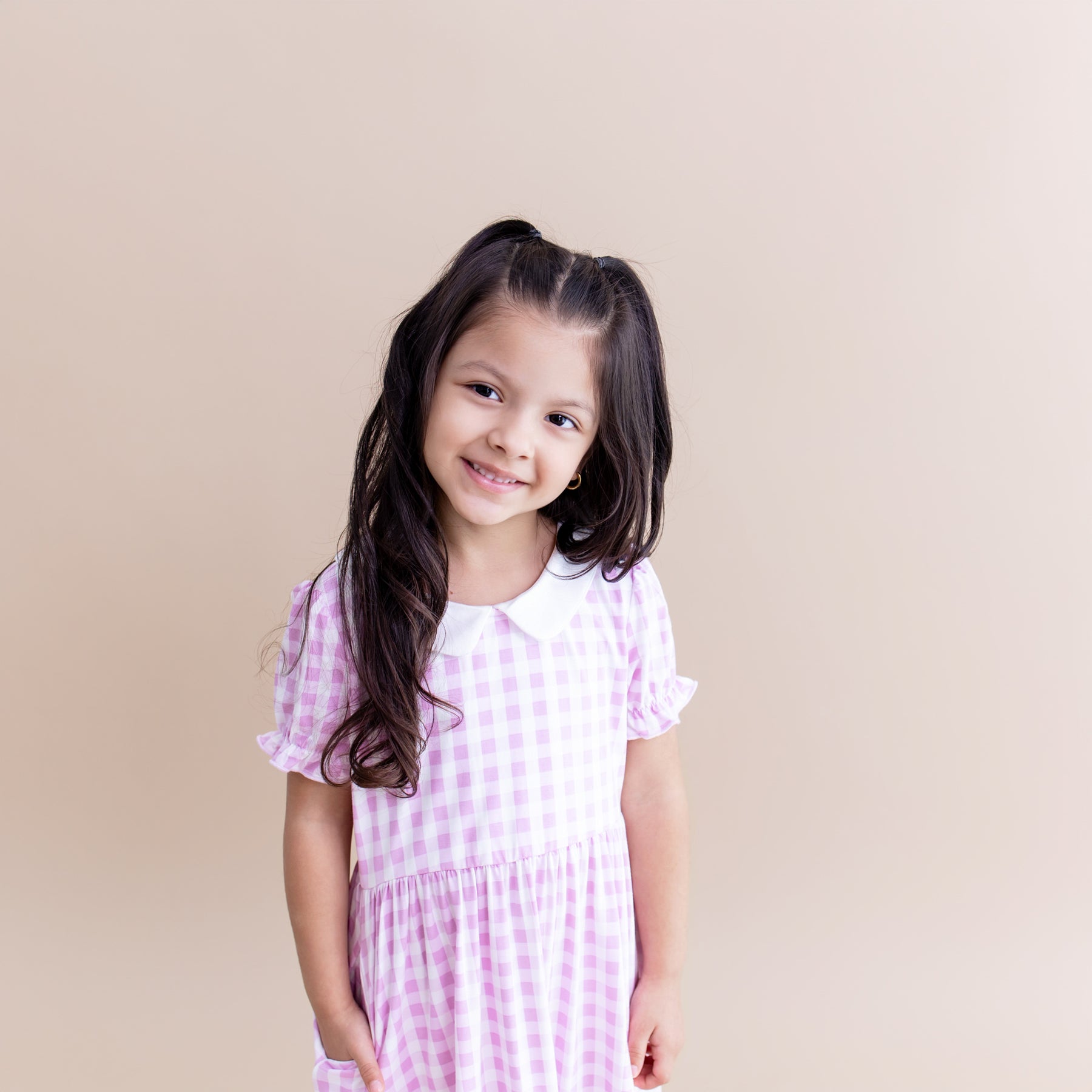Close up of young girl wearing the Peter Pan Collar Dress in Gingham Thistle