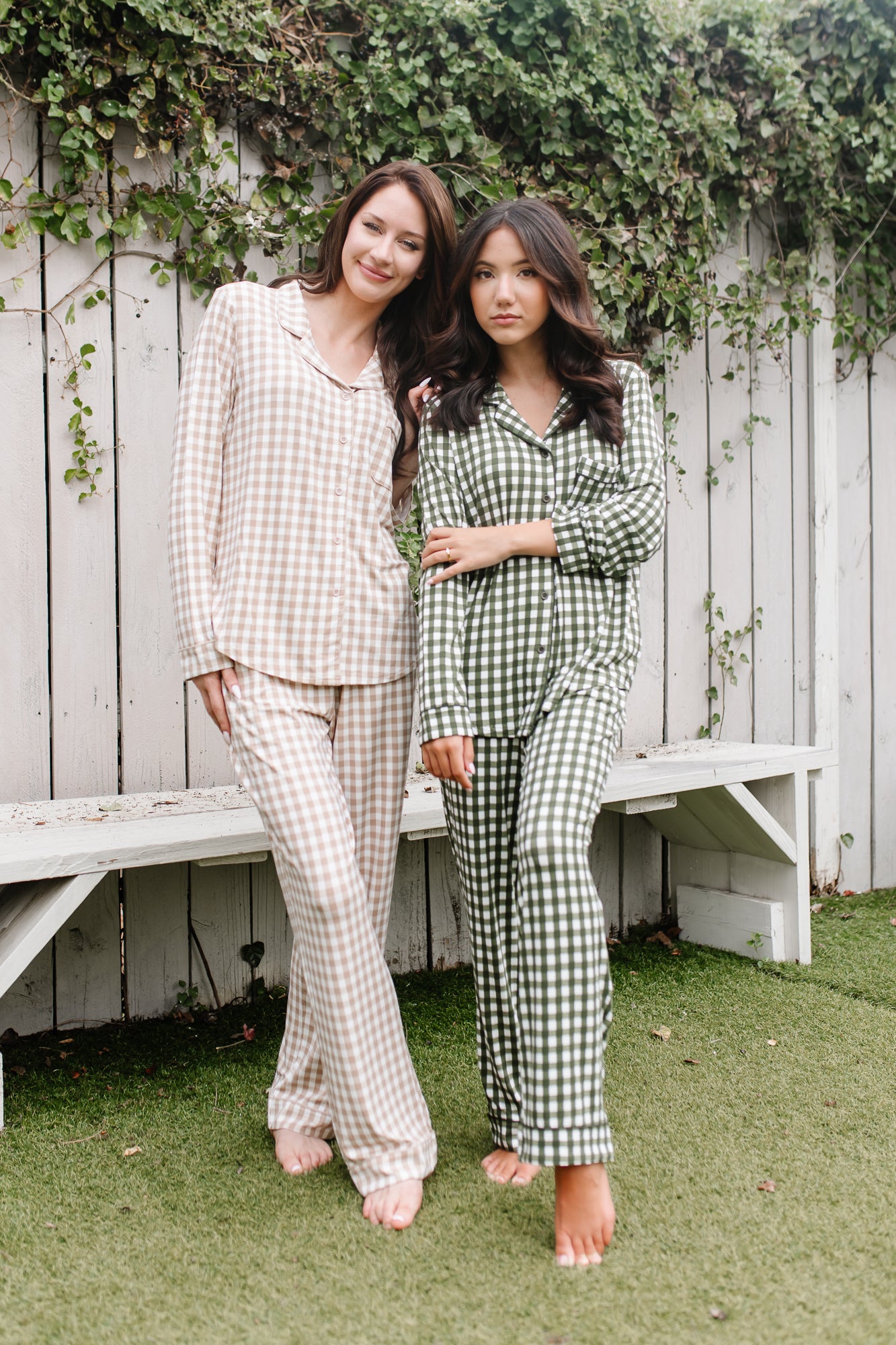 Two female models standing side by side wearing the Long-Sleeved Women's Pajama Set in Gingham Fir and Gingham Bisque
