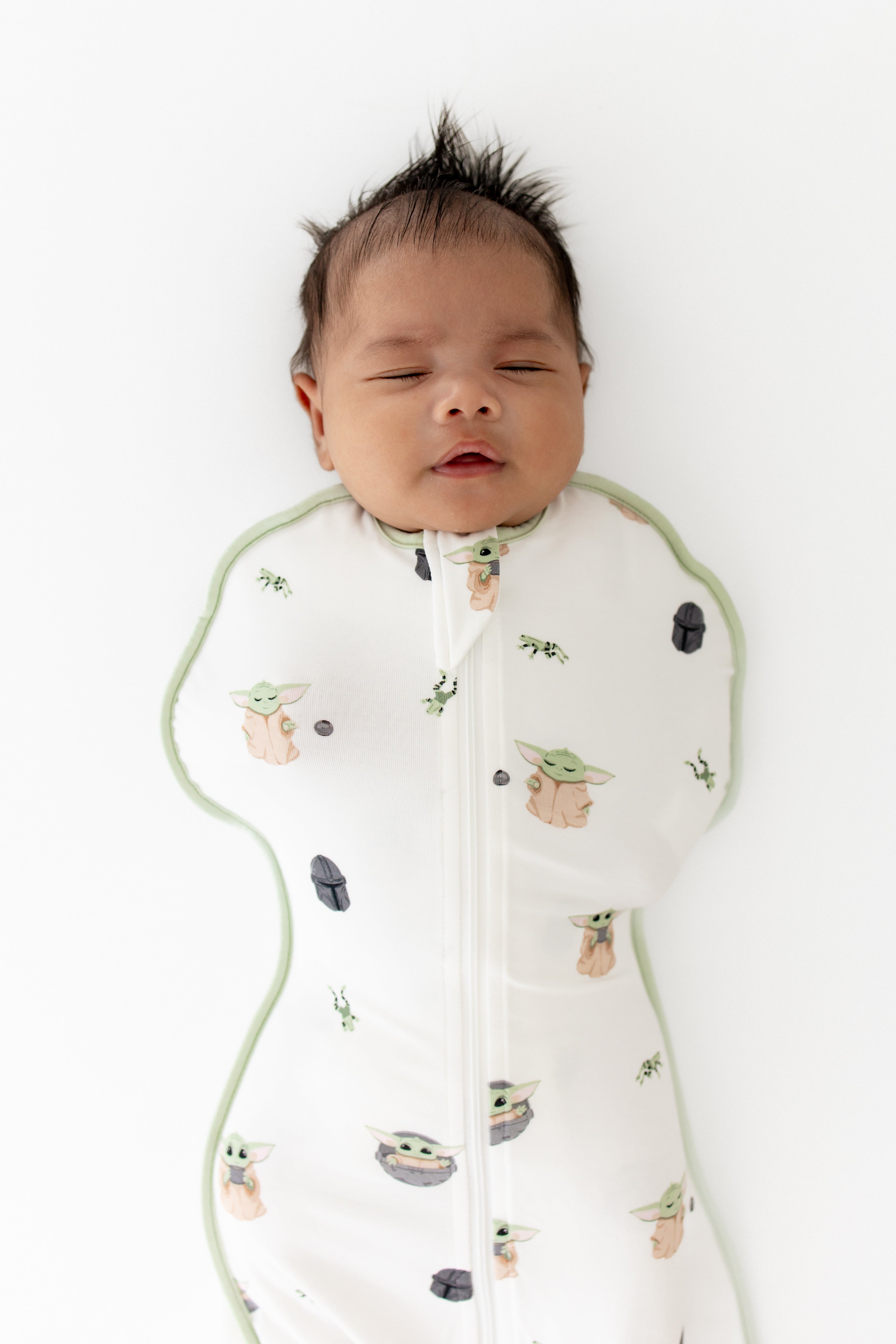 Close up of sleeping newborn wearing the Swaddle Bag in Grogu™ 0.5