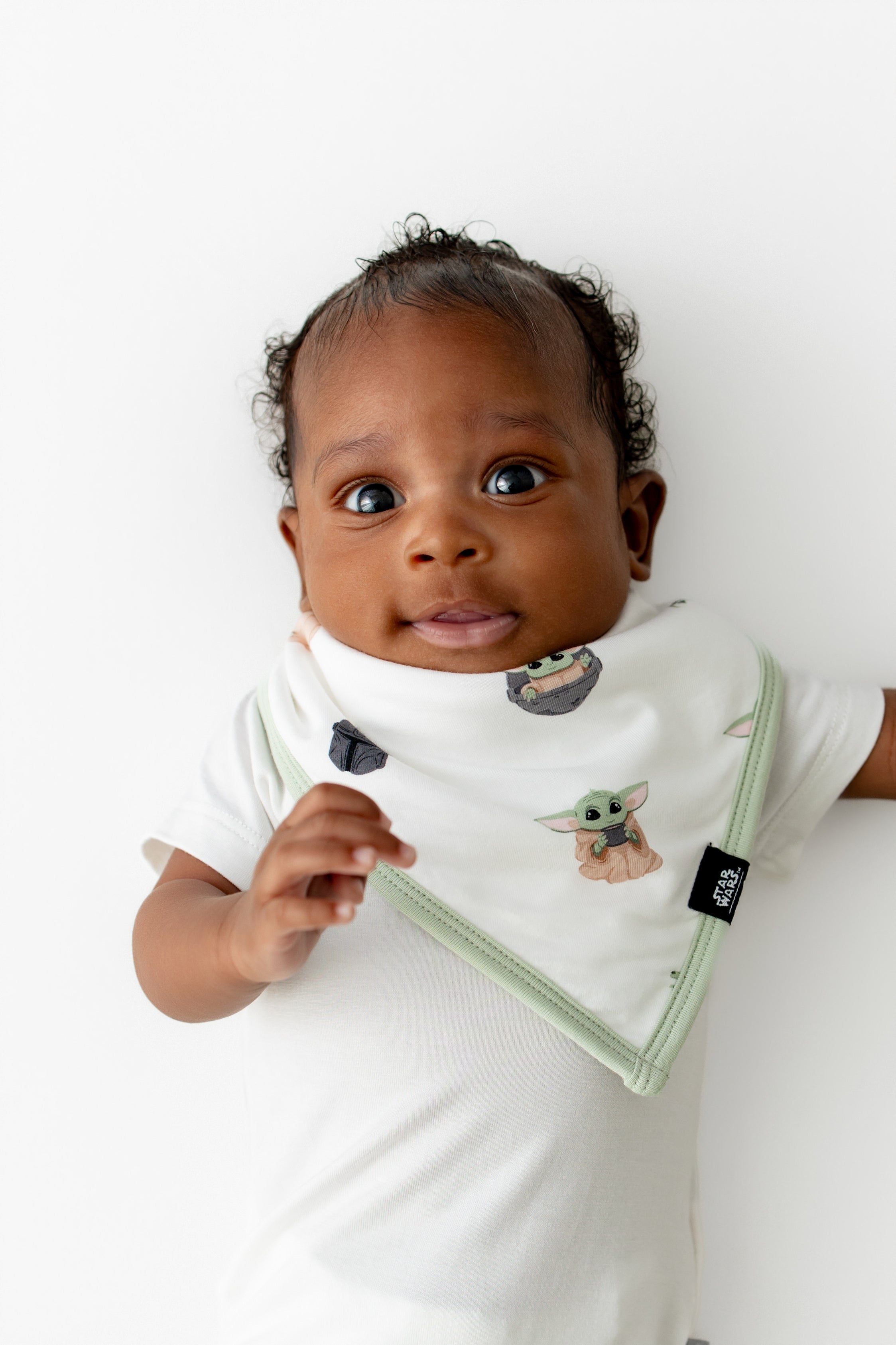 Close up of infant wearing the Bib in Grogu™ with a white short sleeve bodysuit