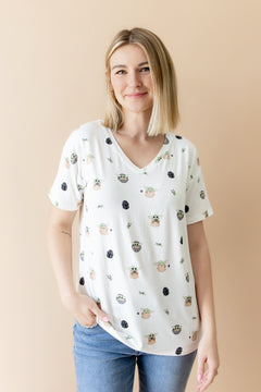 Smiling female model posing wearing the Women's Relaxed Fit V-Neck in Grogu™ with medium wash jeans