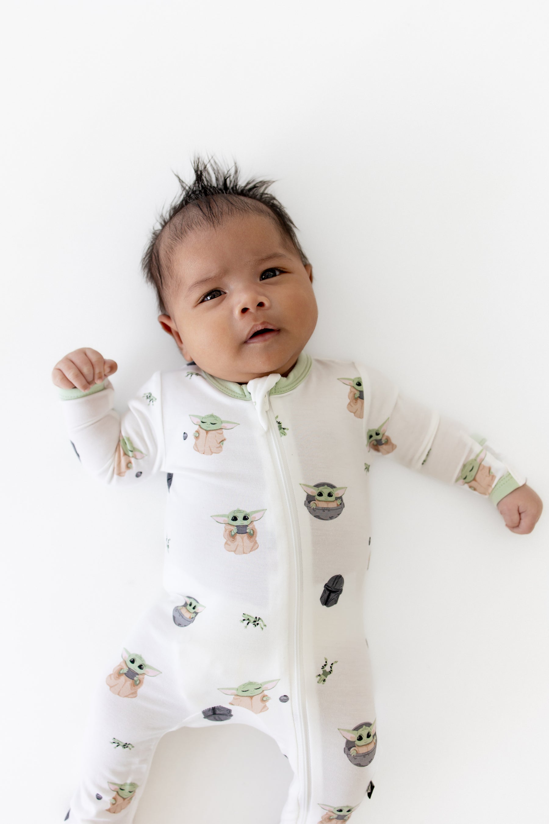 Close up of the Zippered Footie in Grogu™ shown on an infant