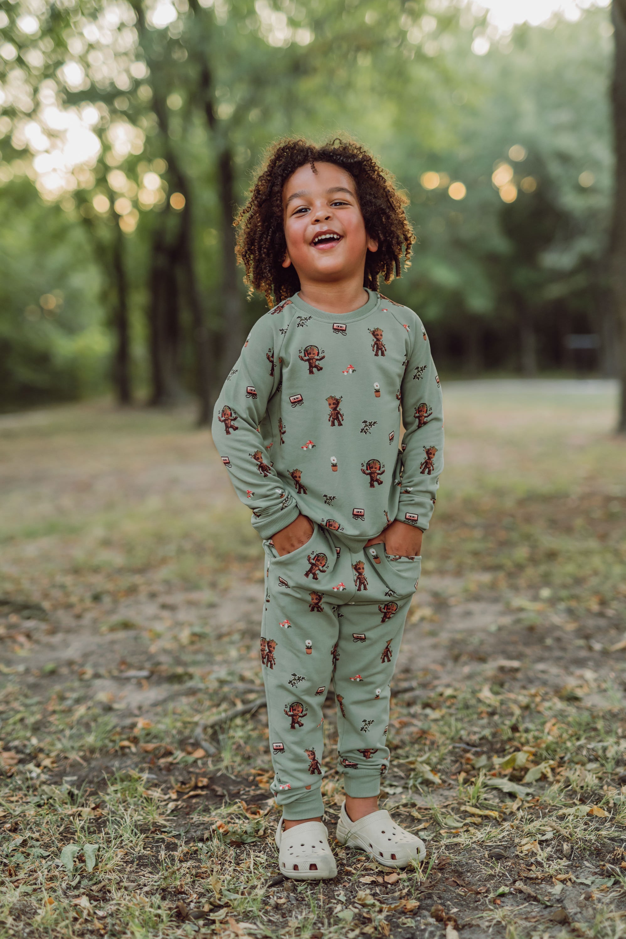 Boy outside with his hands in his pocket wearing groot jogger set.