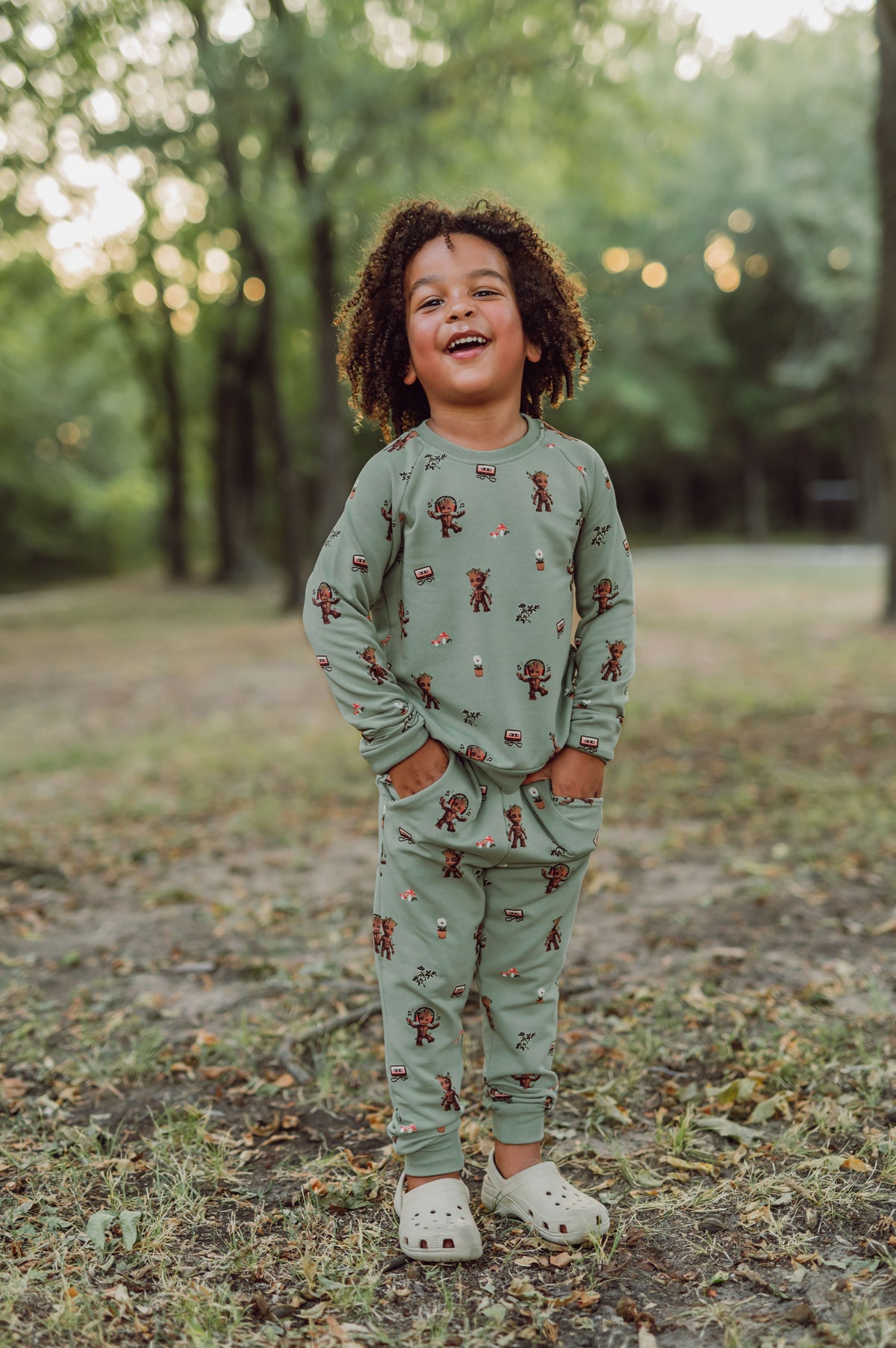 Boy outside with his hands in his pocket wearing groot jogger set.
