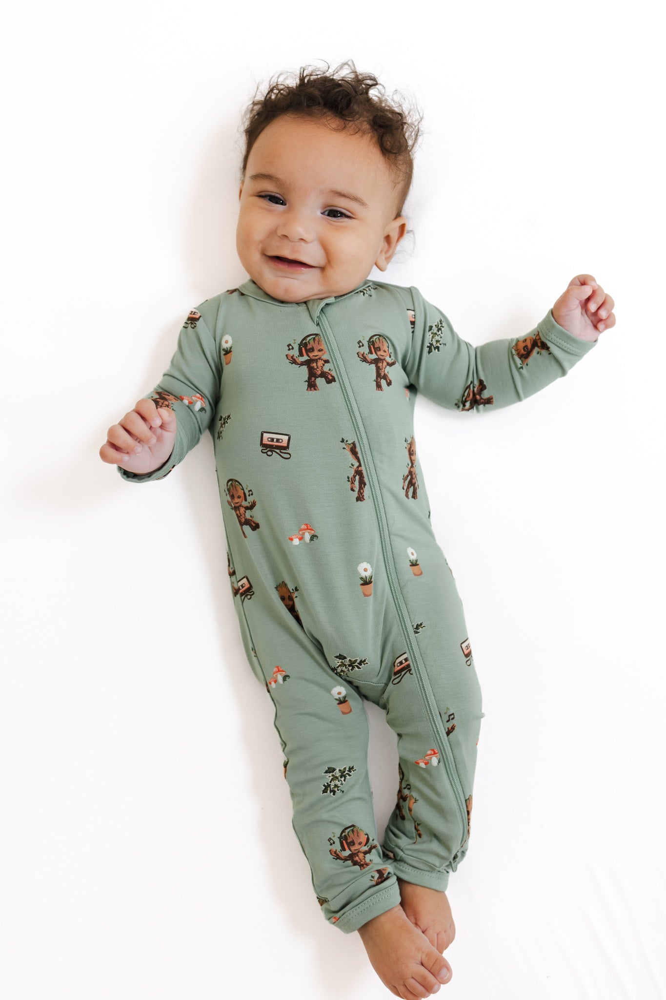 Baby wearing Green Zippered Romper in Groot print on a white background