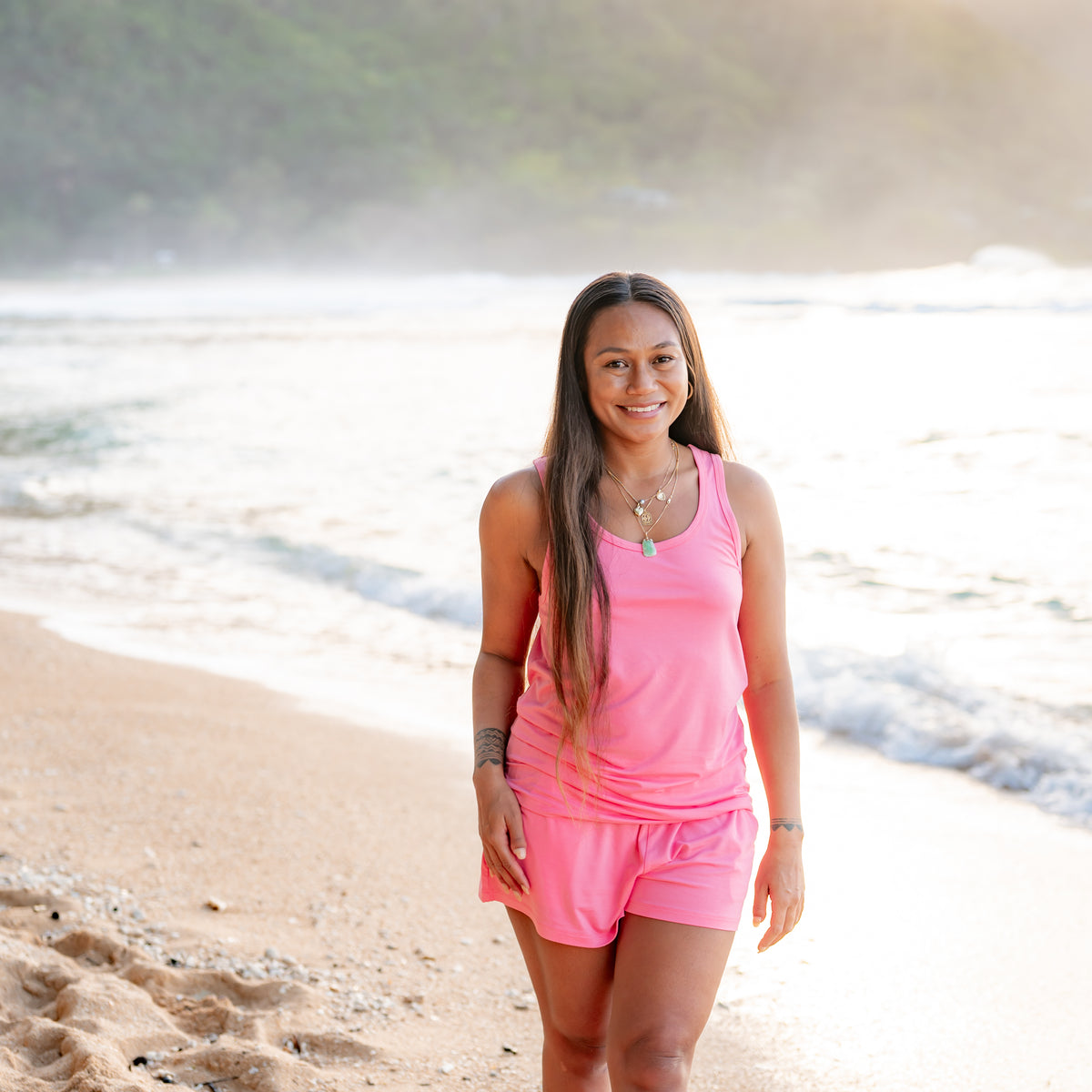 Woman modeling Guava Tank Set on the beach