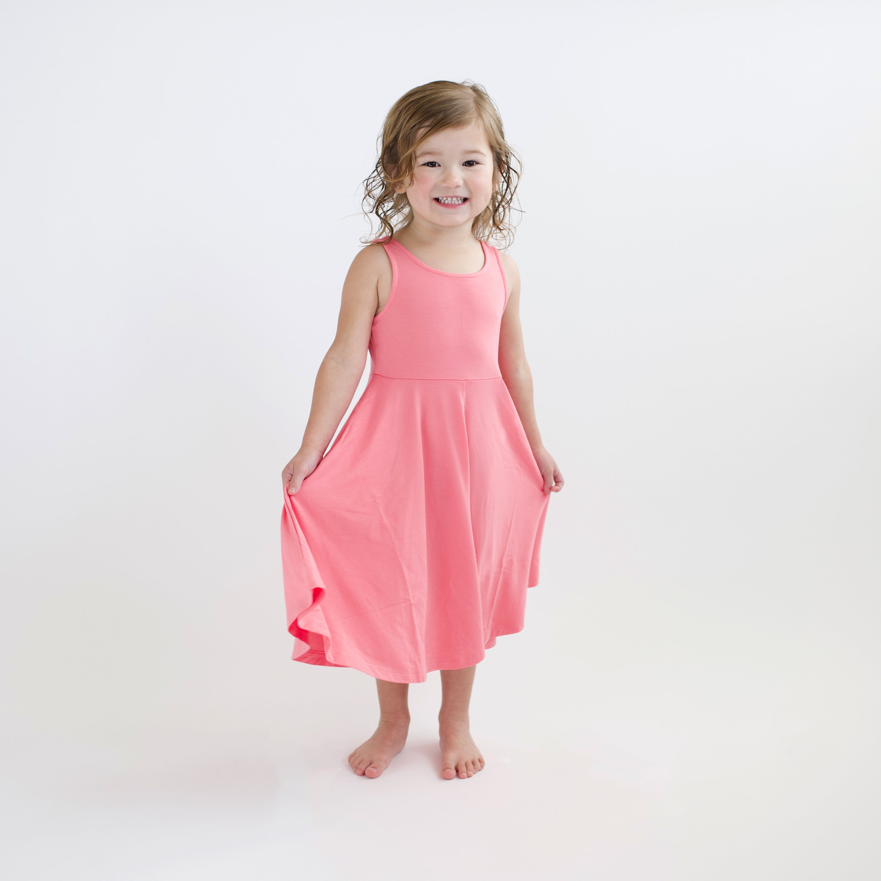 Toddler modeling Tank Twirl Dress in Guava