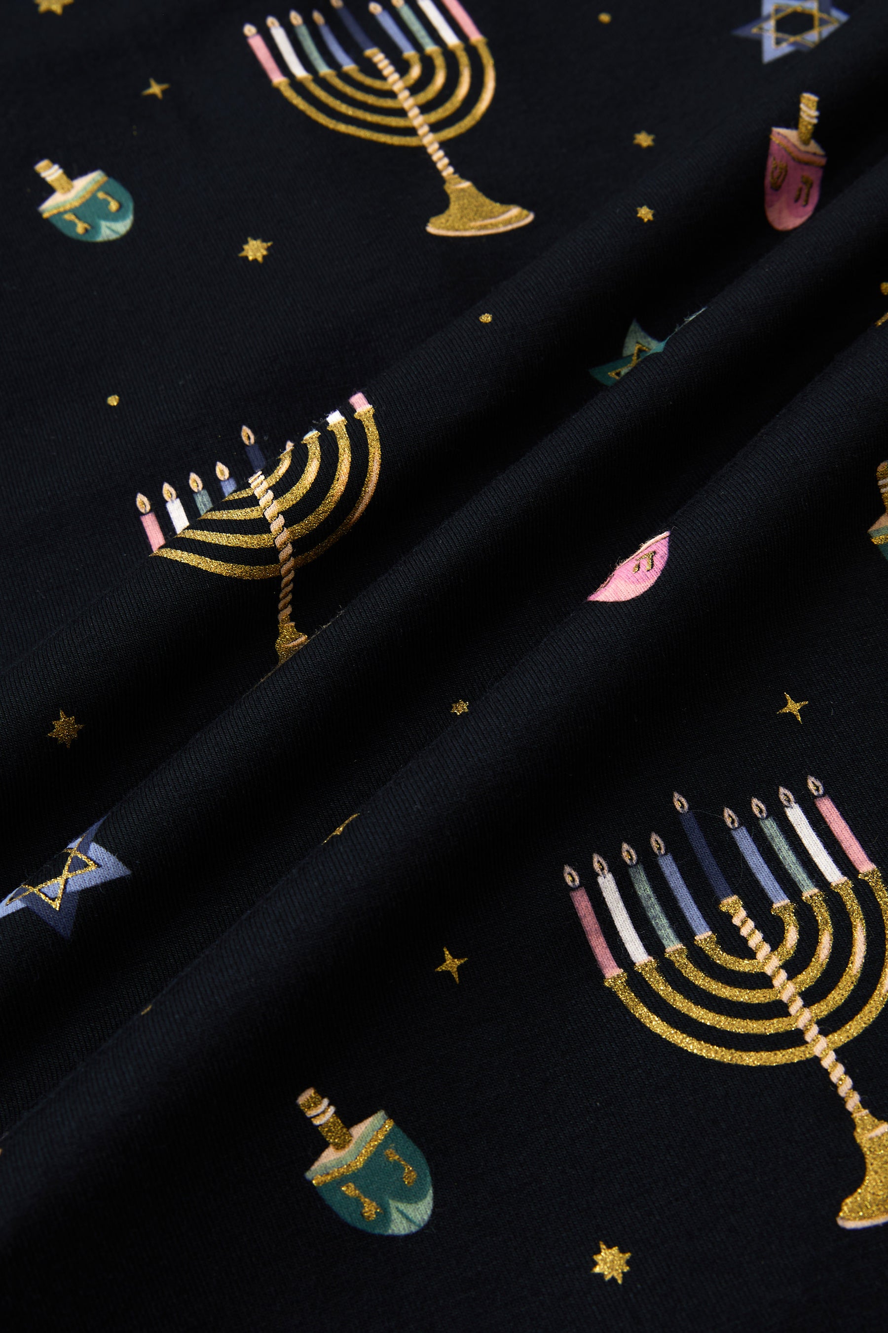 Close up of Black fabric with Hanukkah Nights print 