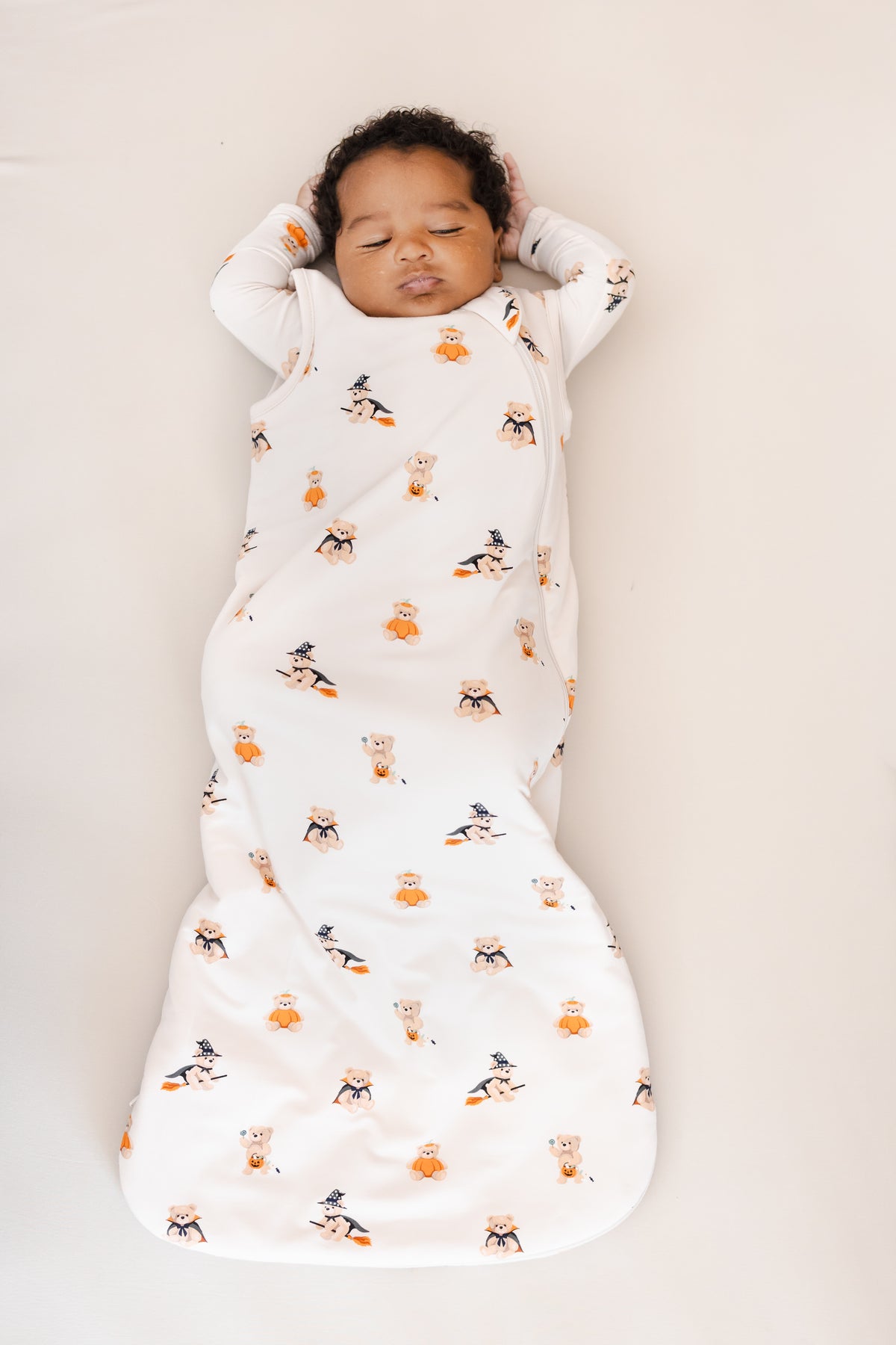 Baby sleeping in Sleep Bag in Halloween Teddy 1.0 print on a beige background