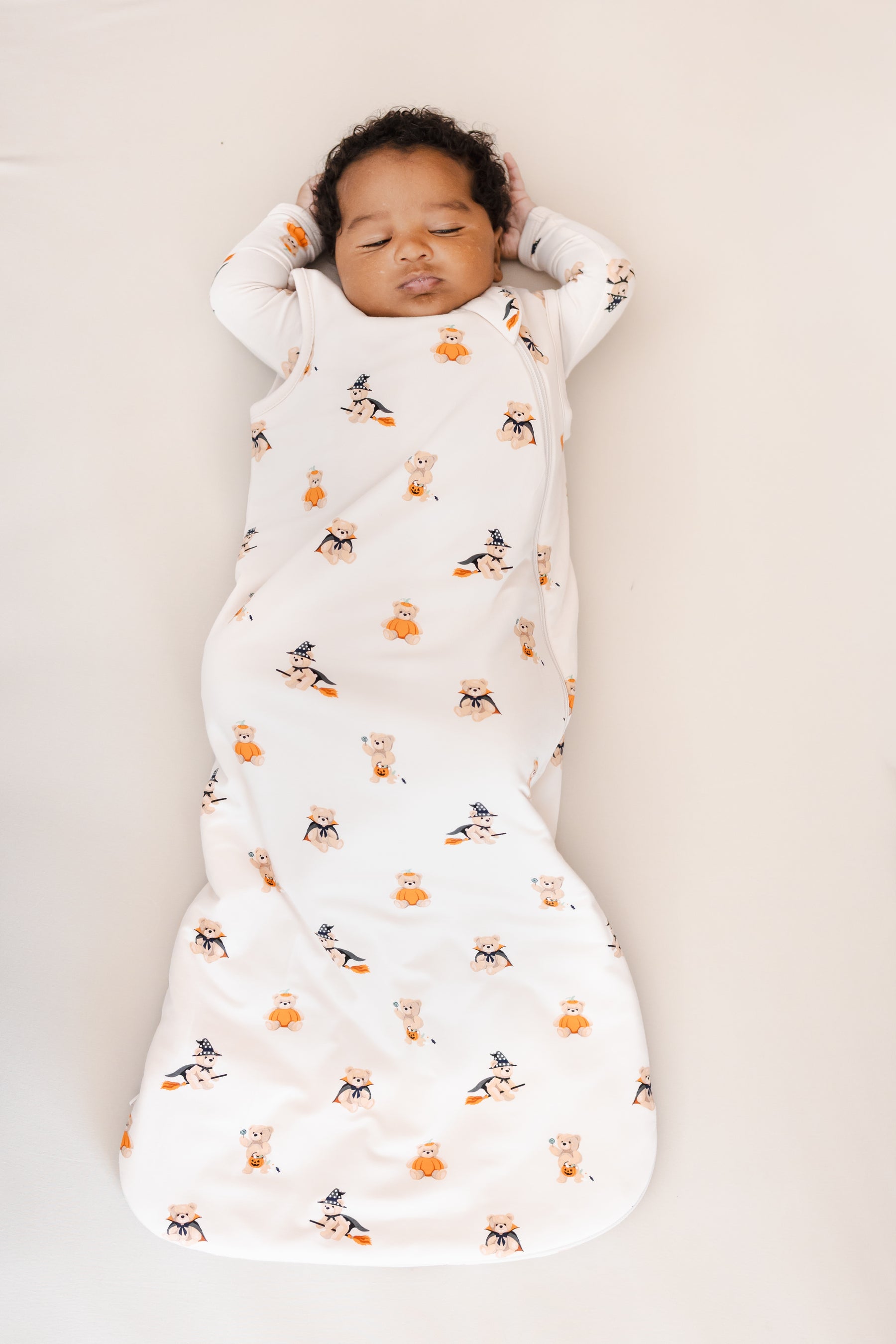 Baby sleeping in Sleep Bag in Halloween Teddy 1.0 print on a beige background