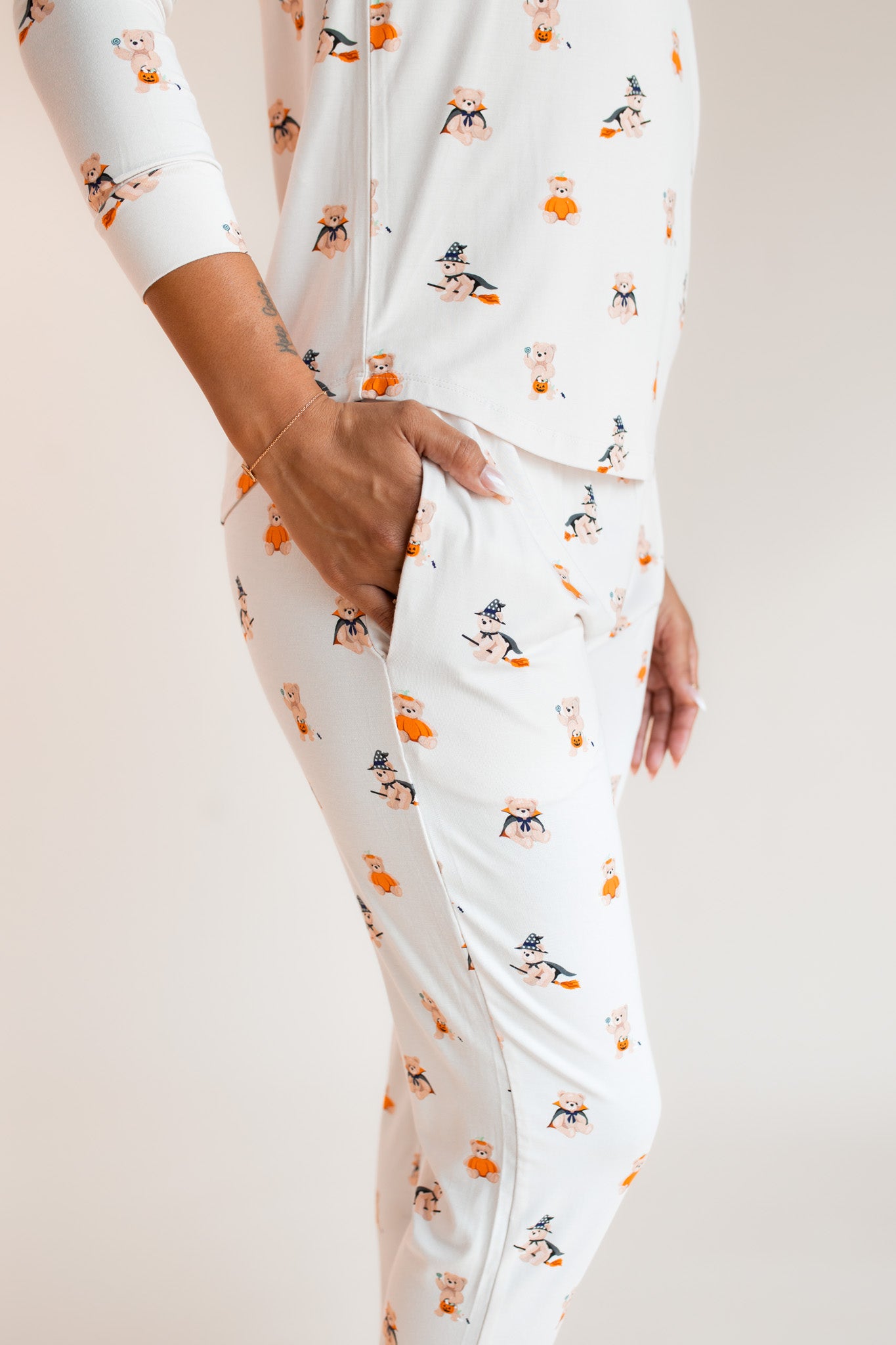 Modal showcasing the jogger pajama pockets of Women's Jogger Pajama Set in Halloween Teddy print on a beige background