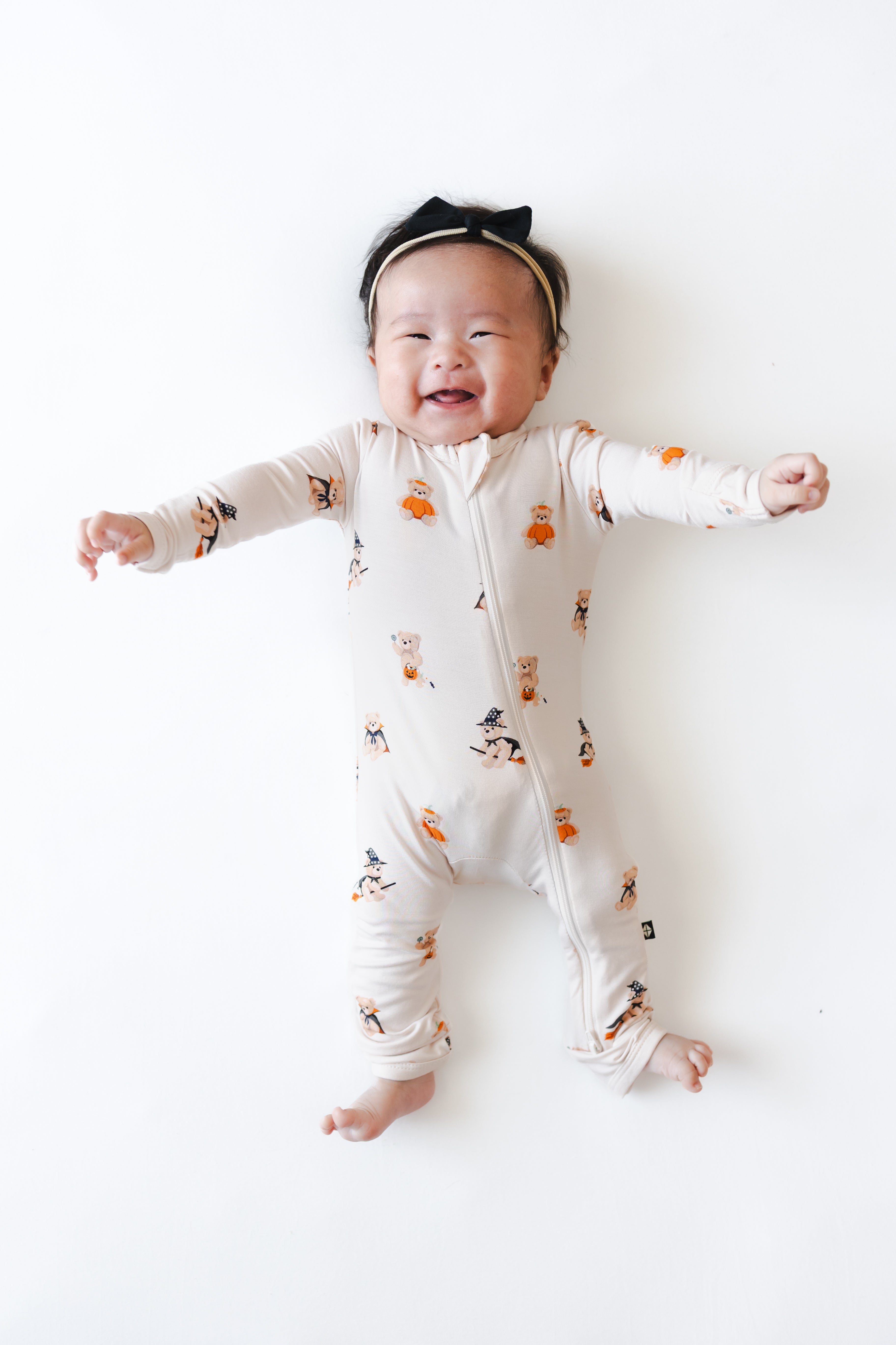 Baby smiling Zippered Romper in Halloween Teddy print on a white background