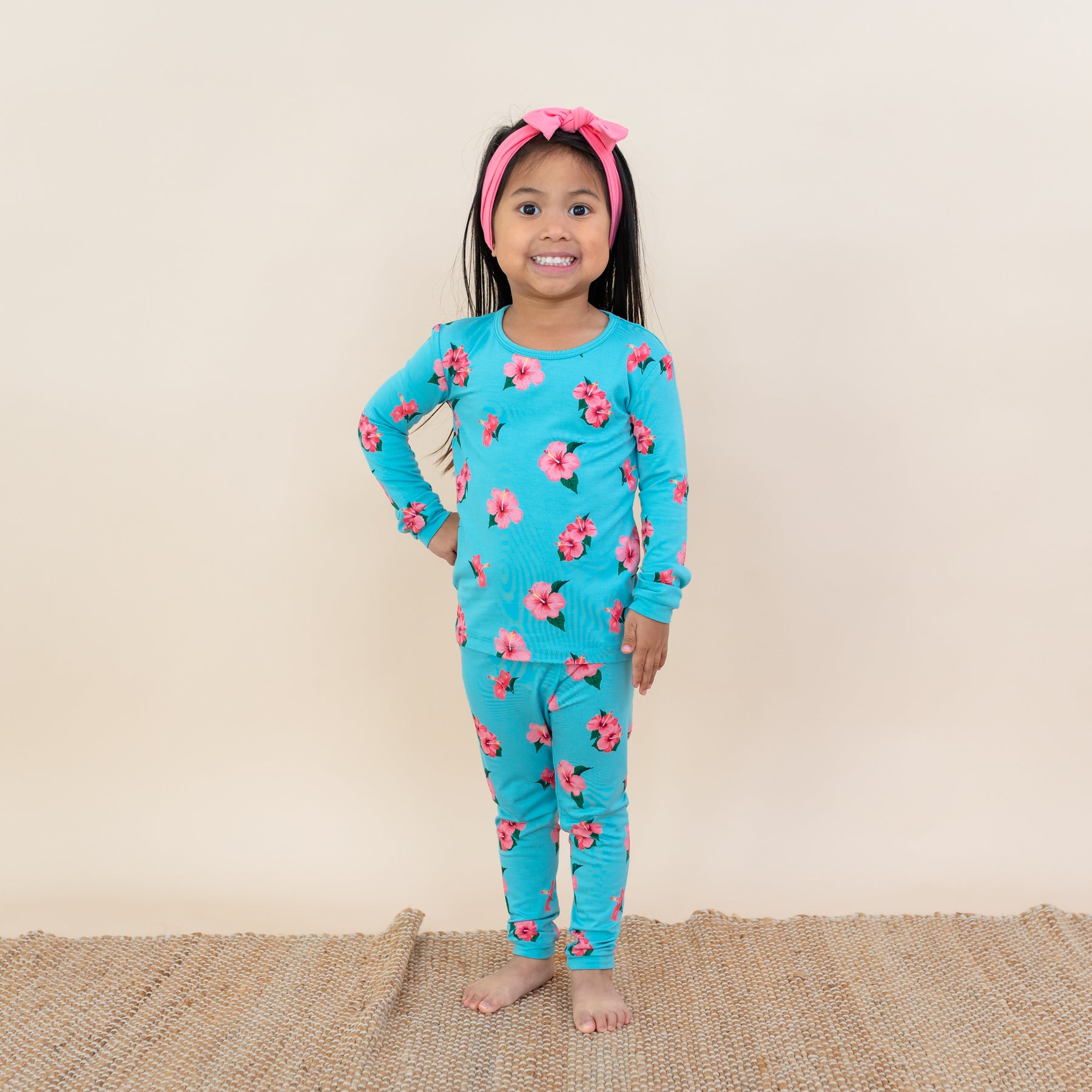 Toddler modeling Kyte Long Sleeve Pajamas in Hibiscus