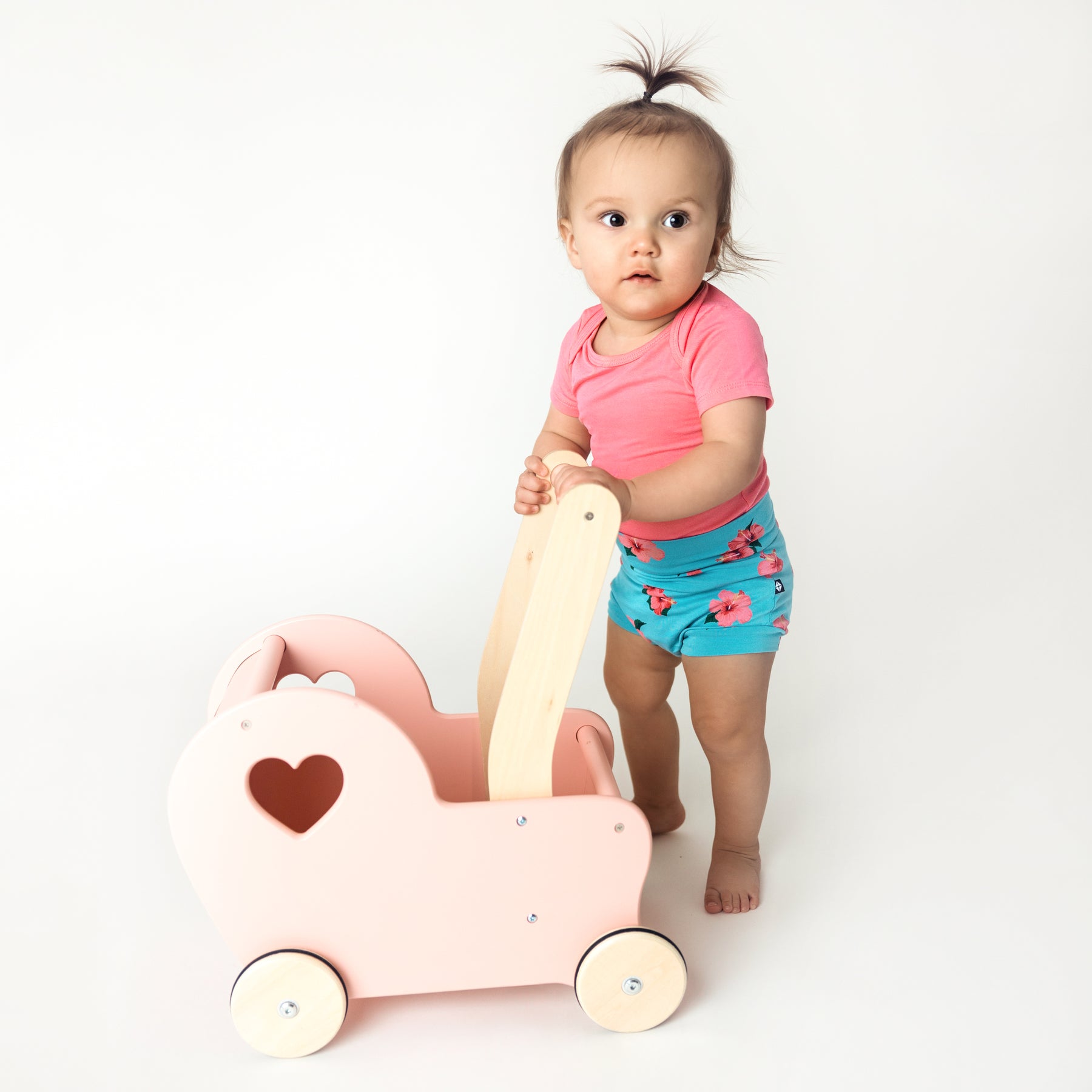 toddler wearing hibiscus bummies and guava short sleeve bodysuit