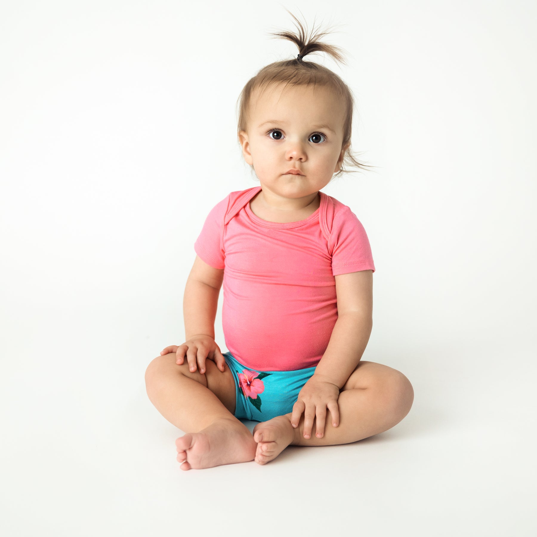 hibiscus bummies and guava bodysuit modeled on a young toddler 