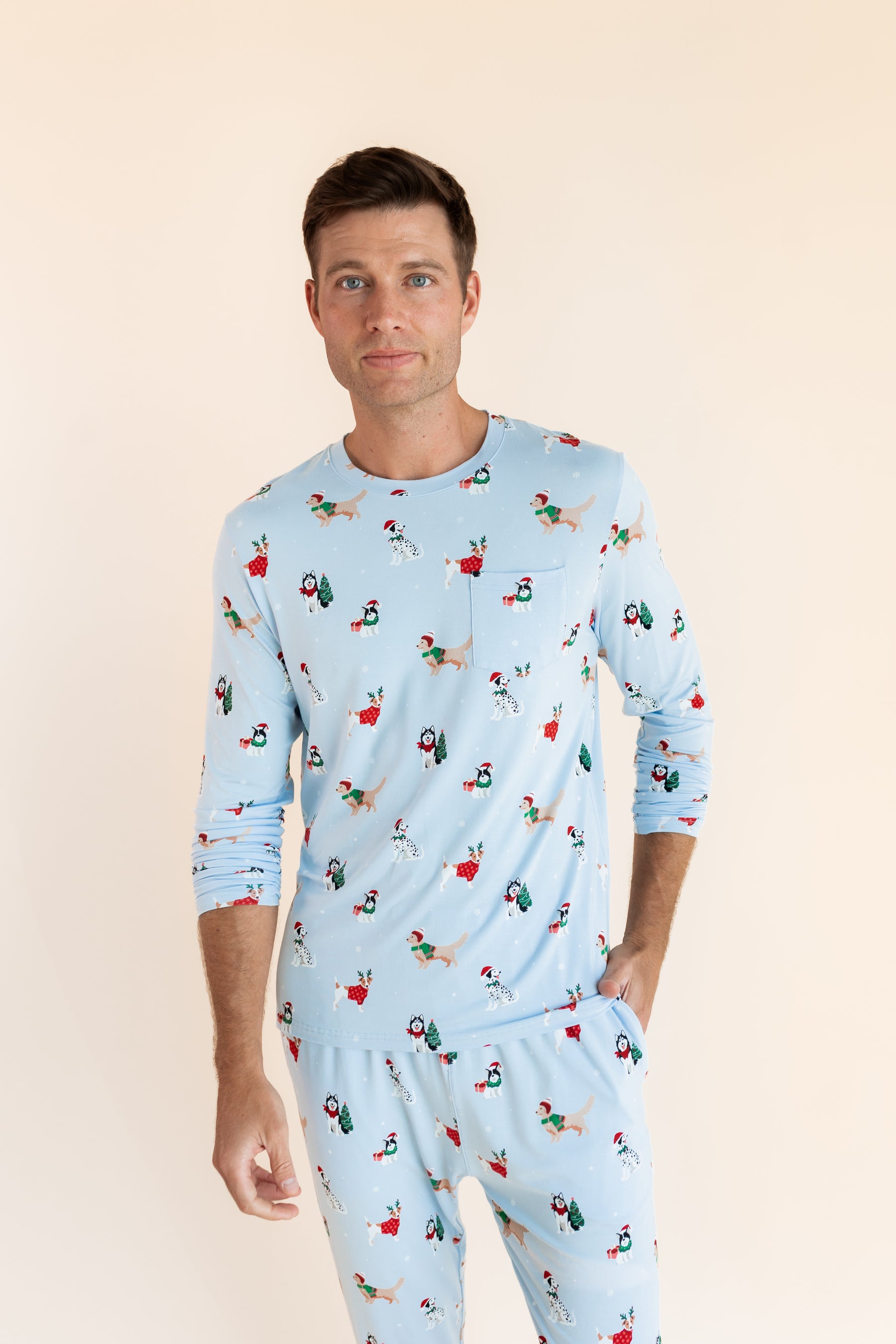 Man posing in Men's Jogger Set in Holiday Pups print on a beige background