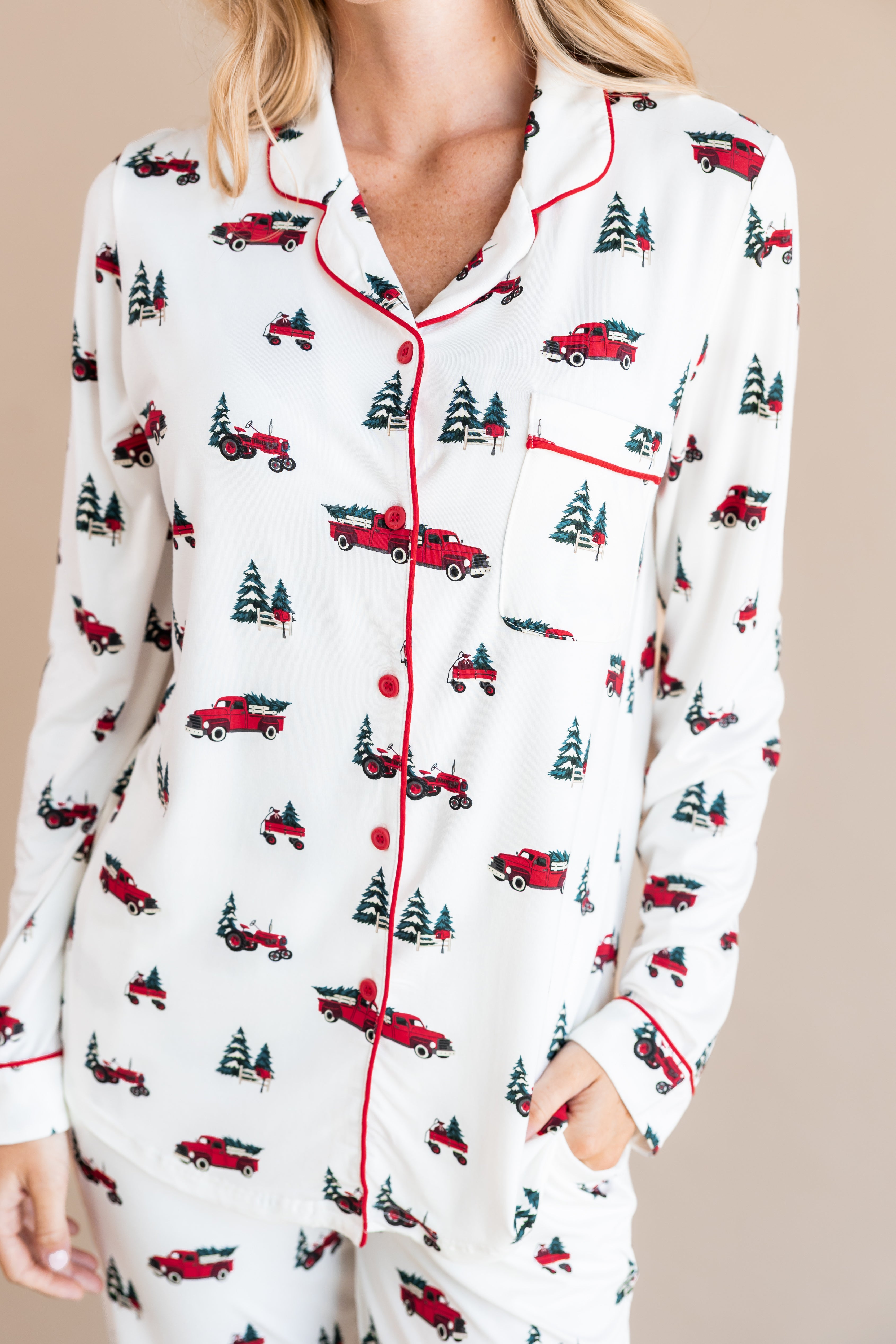 Modal wearing women's Long sleeve pajama set in Holiday Tree farm with red trim on a beige background