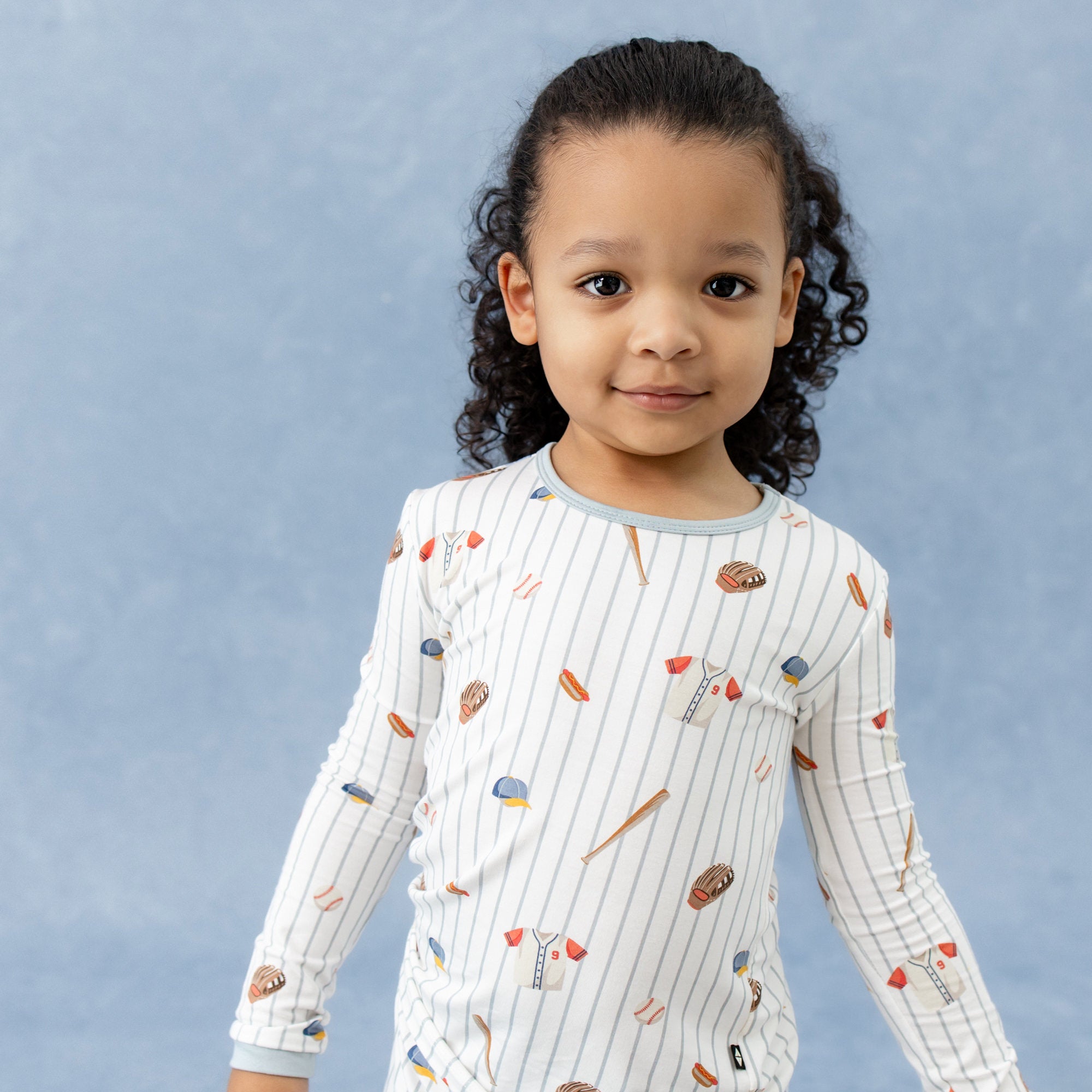 Close up of young girl wearing the Long Sleeve Pajamas in Home Run