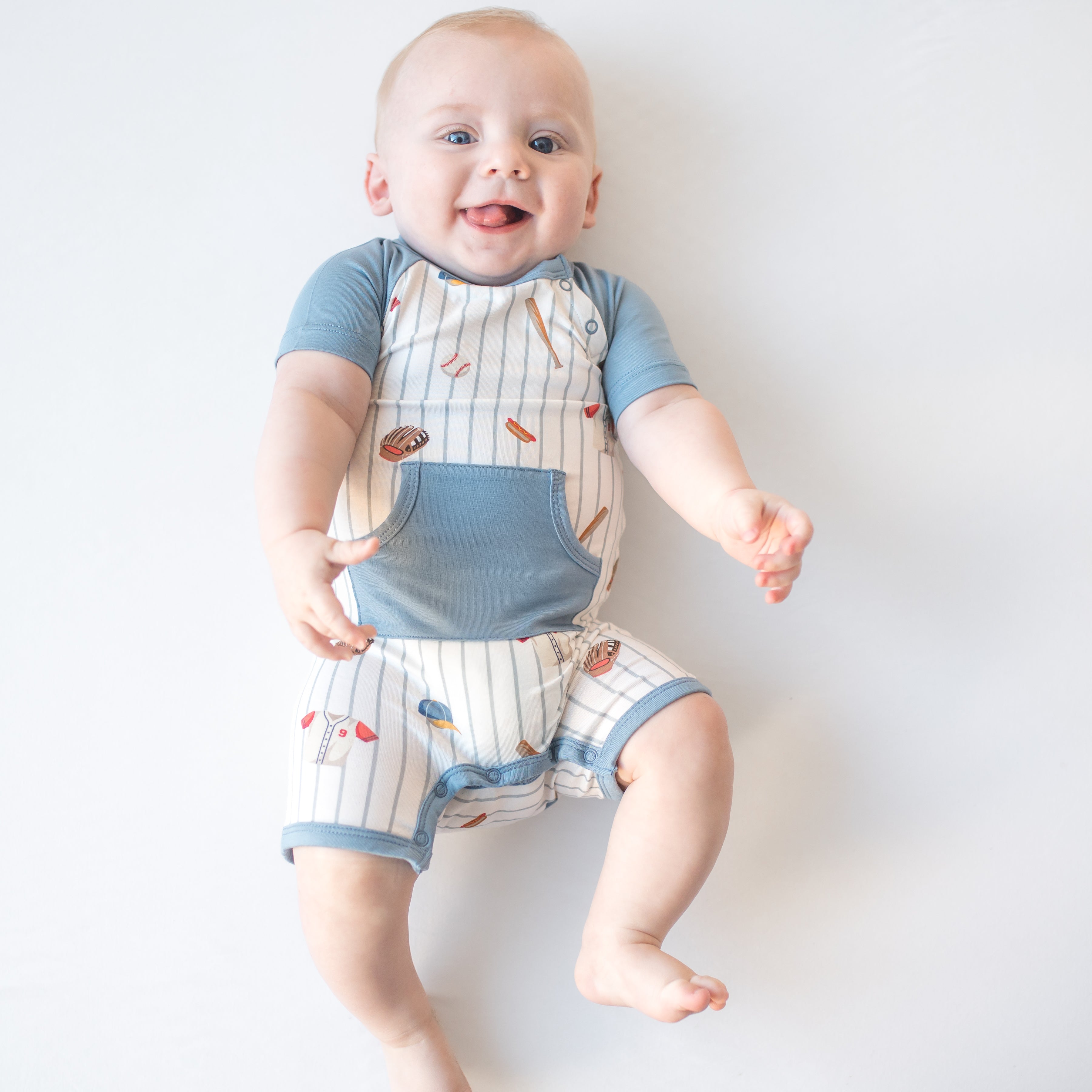 Smiling infant waring the Shortall in Home Run