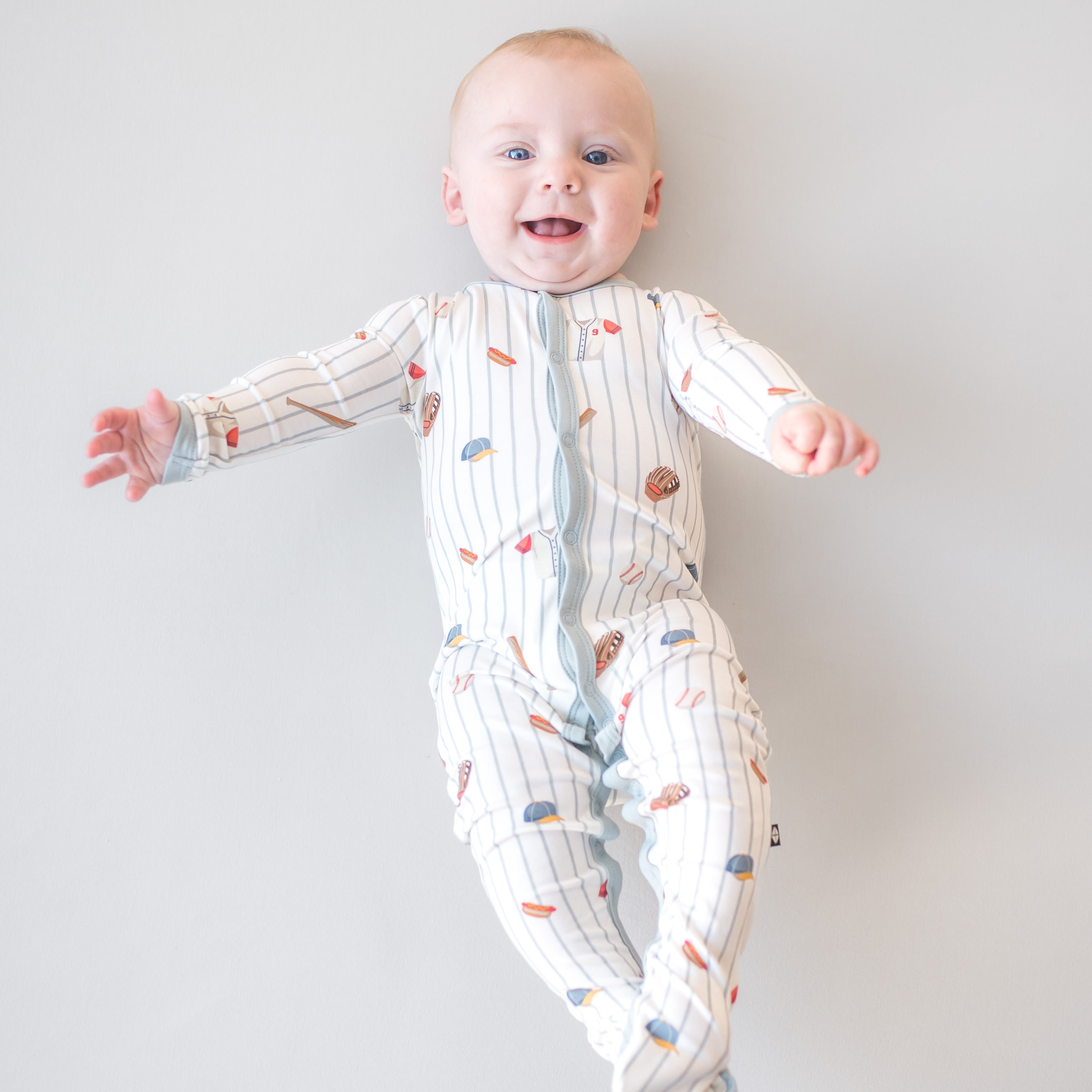 Smiling infant waering the Footie in Home Run