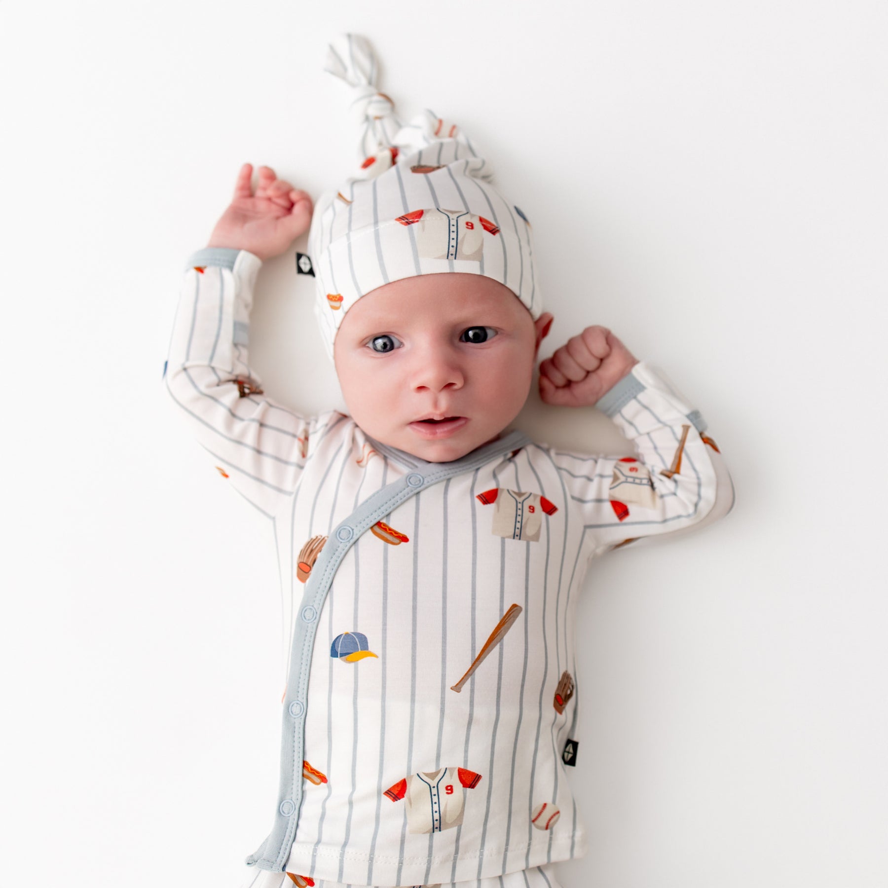 Close up of newborn wearing the Take Me Home Set with Cap in Home Run