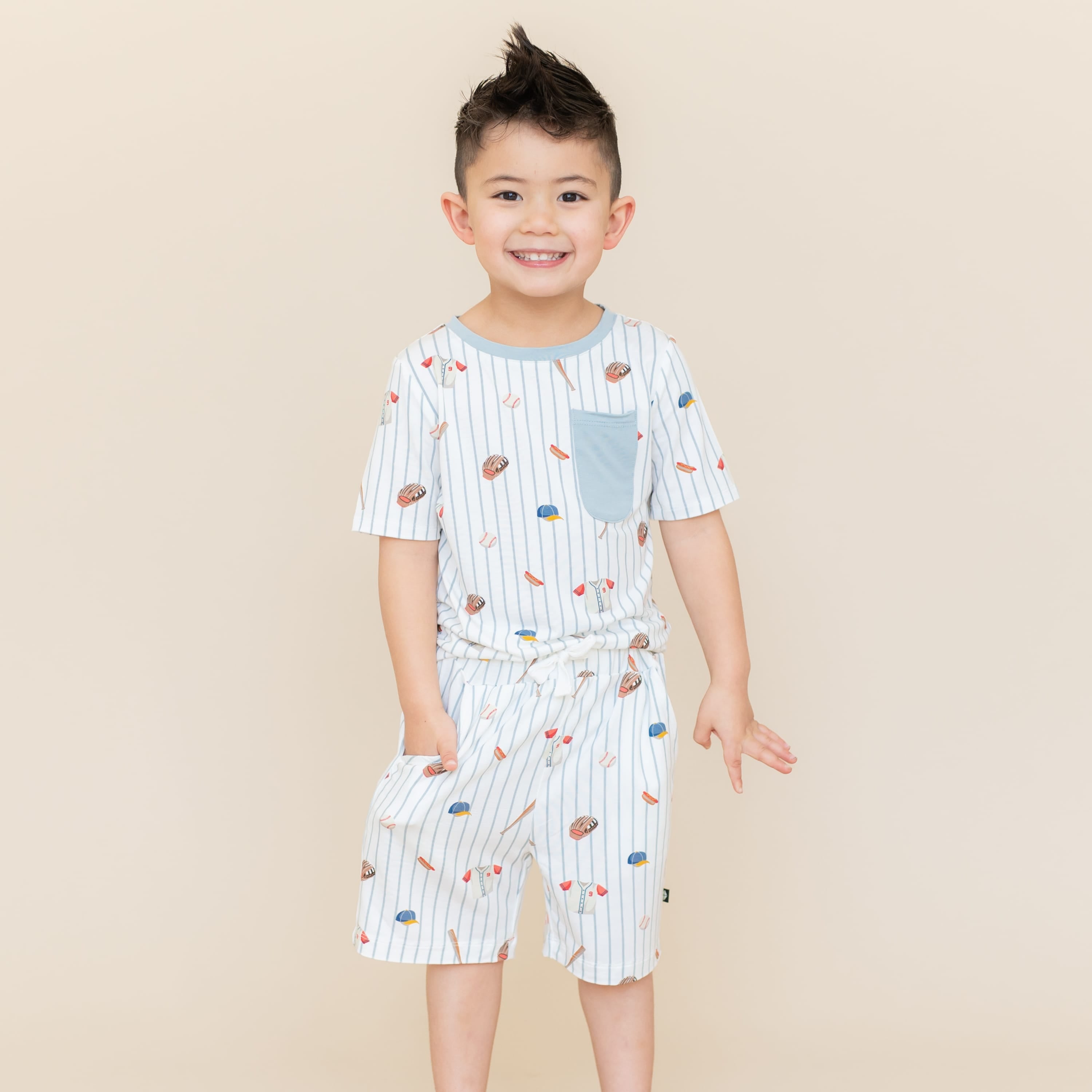 Young boy wearing the Toddler Crew Neck Tee in Home Run paired with matching Drawstring Shorts in Home Run