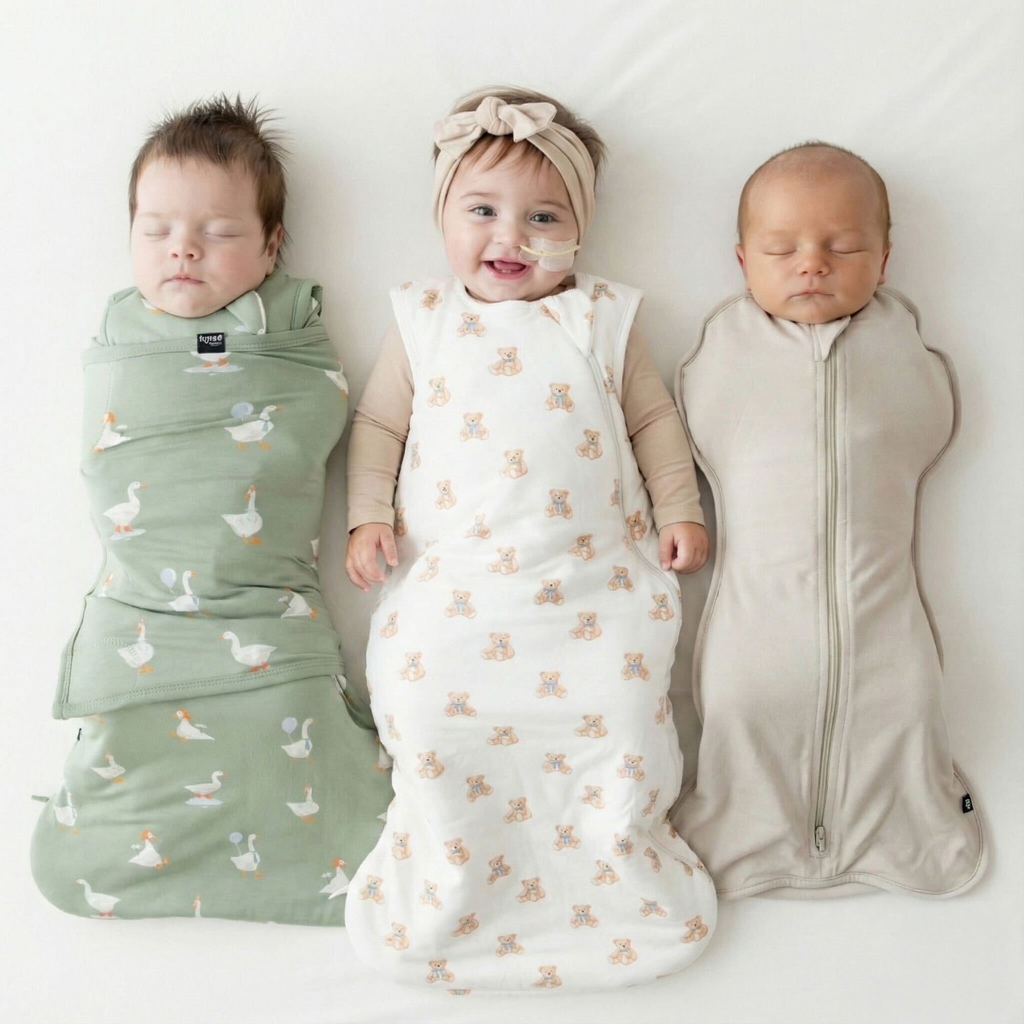 3 babies in Kyte Baby bamboo sleep bag styles