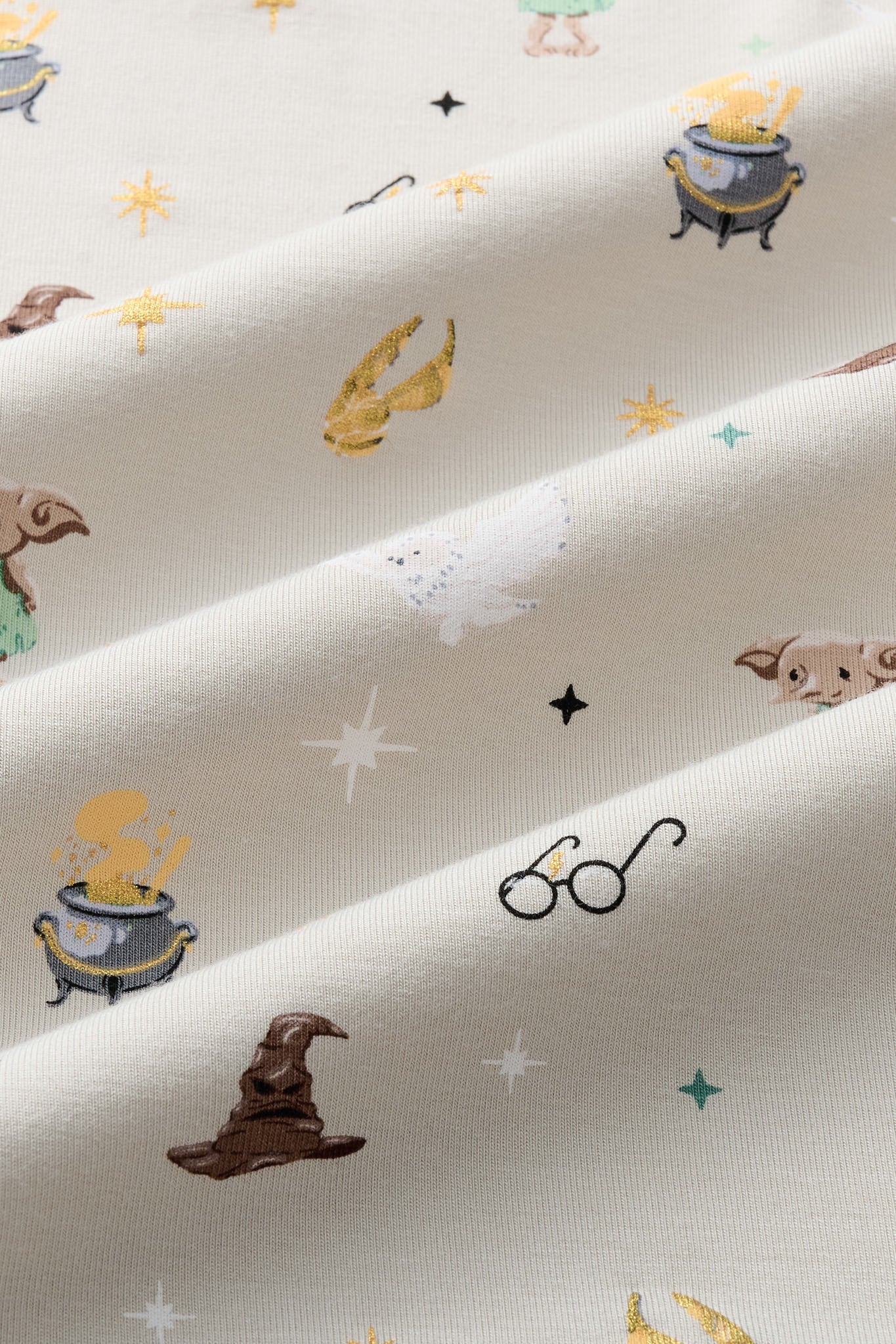 Close up of Beige fabric with Starry Icon Harry Potter patten print