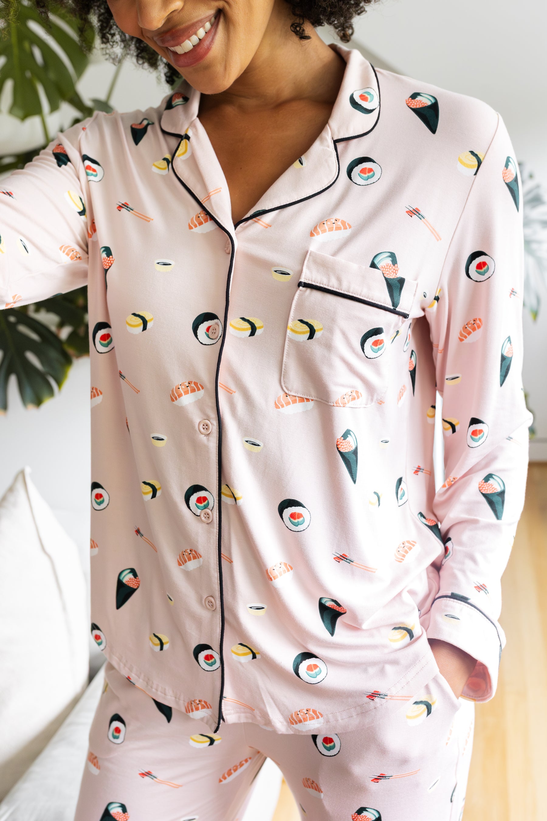 Person wearing a pink pajama set with sushi pattern