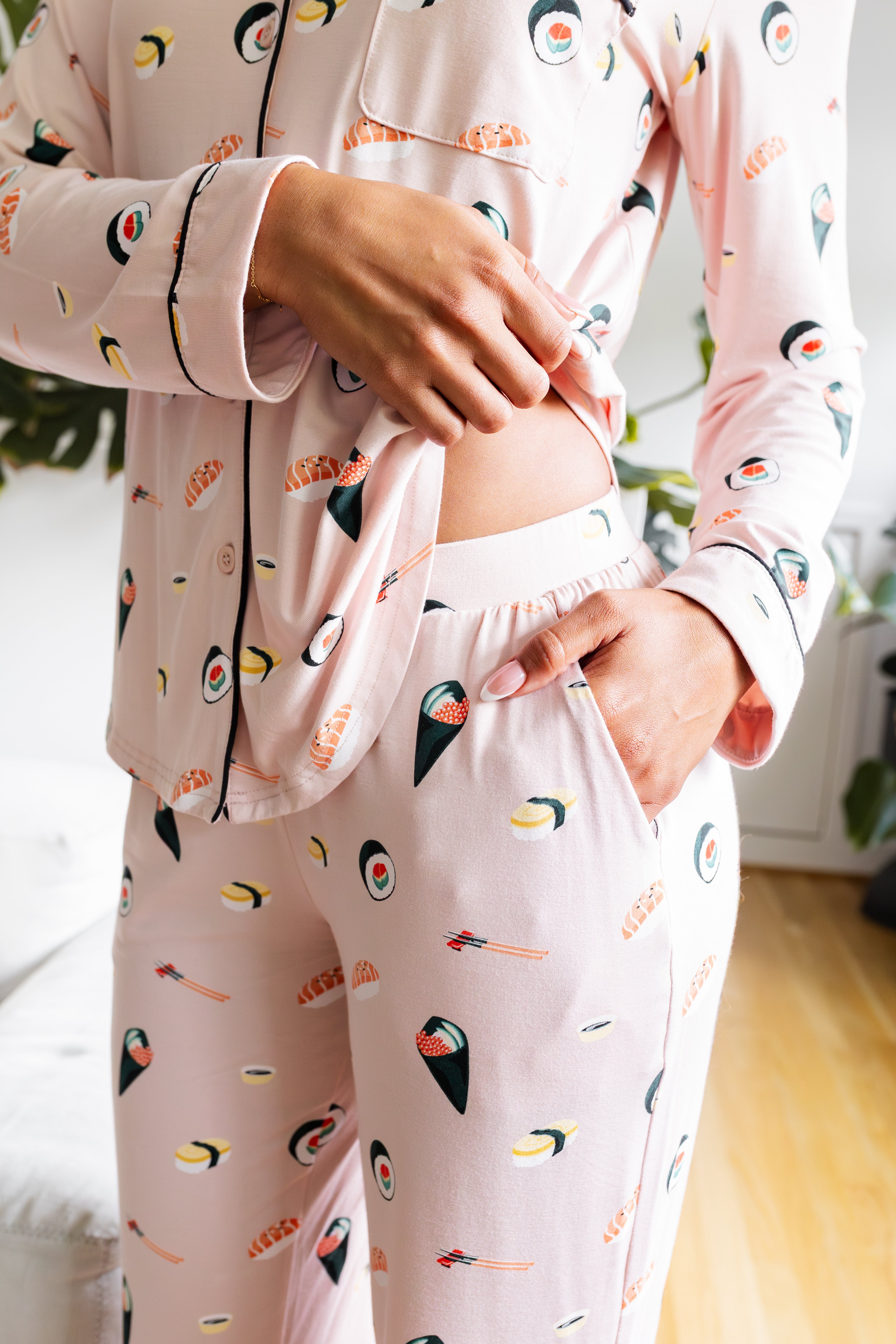 Person wearing a sushi-themed pajama set in a casual setting.