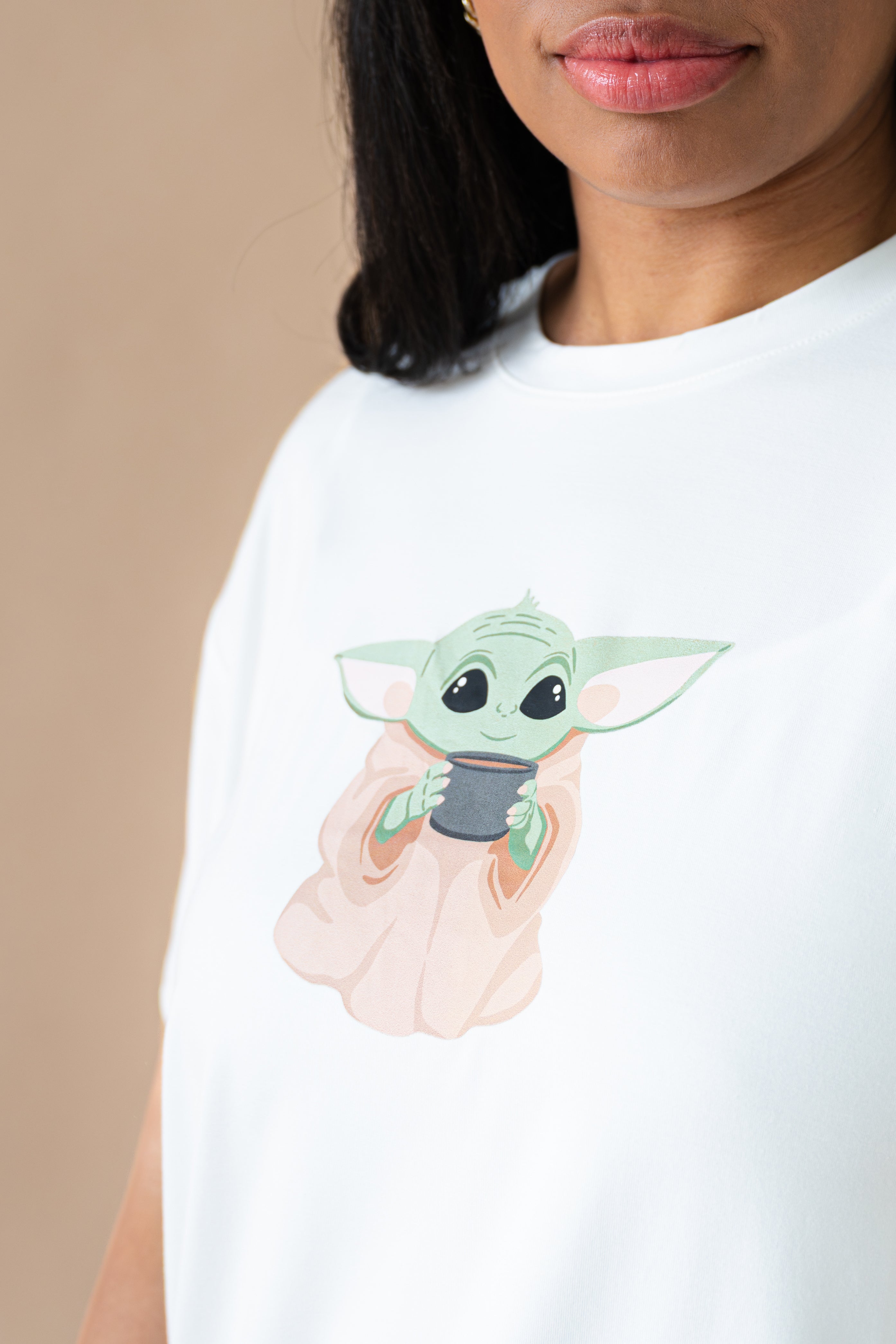 Close up of the Yoda character on a Women's Graphic Tee in The Child™