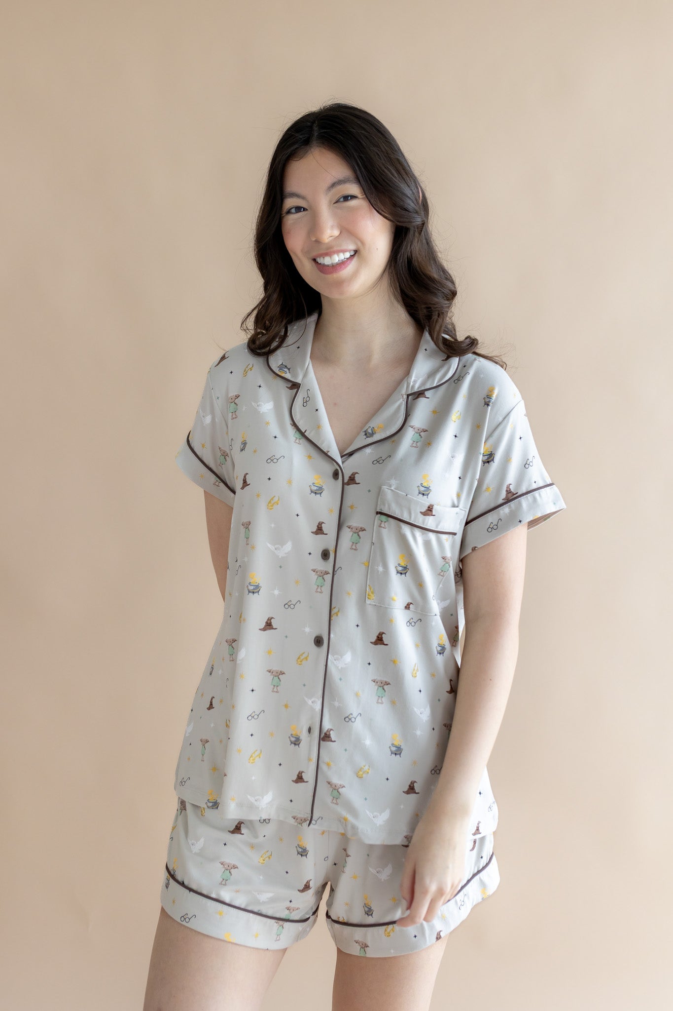 Model wearing Women's Short Sleeve Pajama Set with Harry Potter prints on a beige background